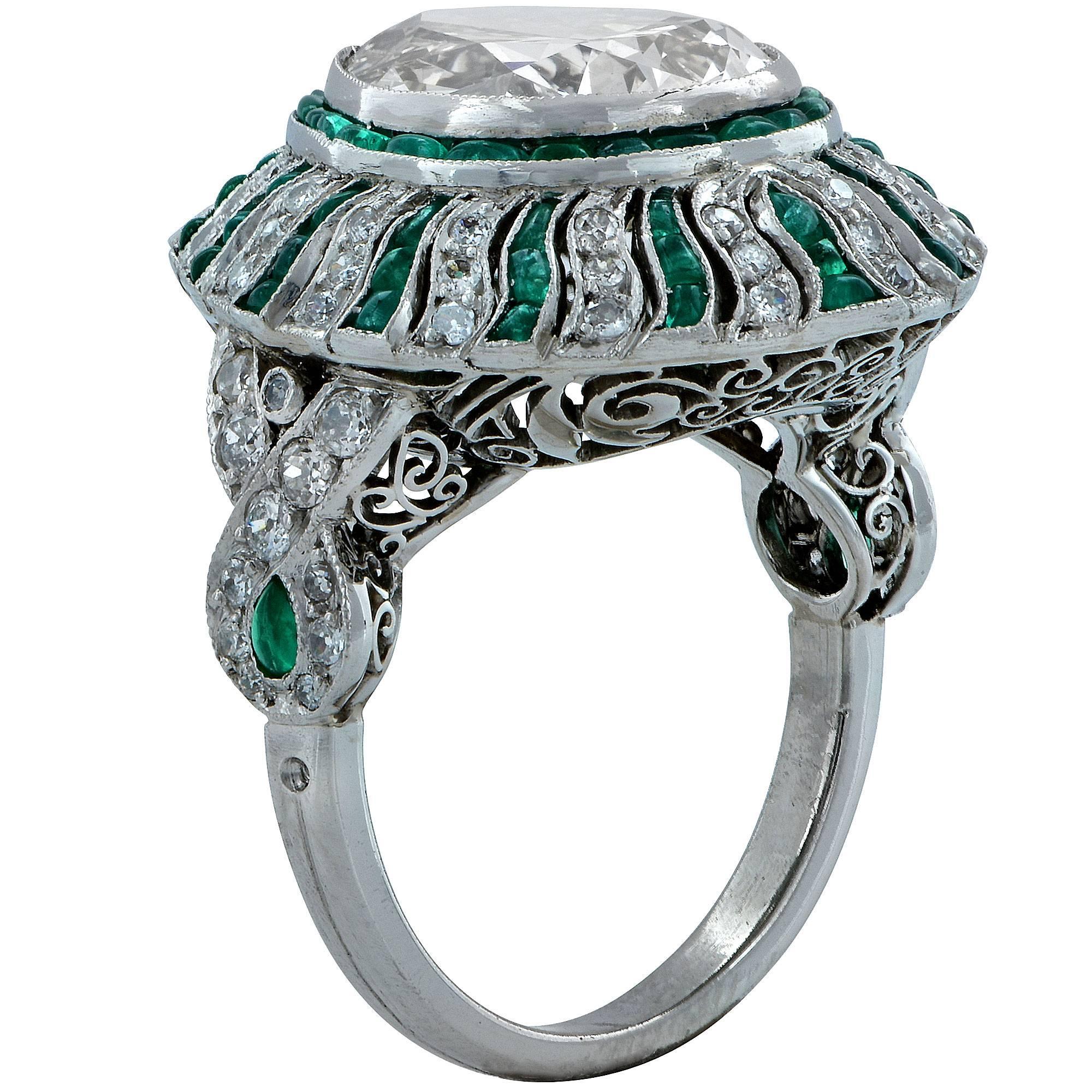 This beautiful handmade Art Deco style ring features a 5.09ct pear shape diamond K-L color VS1 clarity and is accented by .70cts of European cut diamonds and 2cts of emeralds to create a dazzling halo effect.

The ring is a size 6.25 and can be