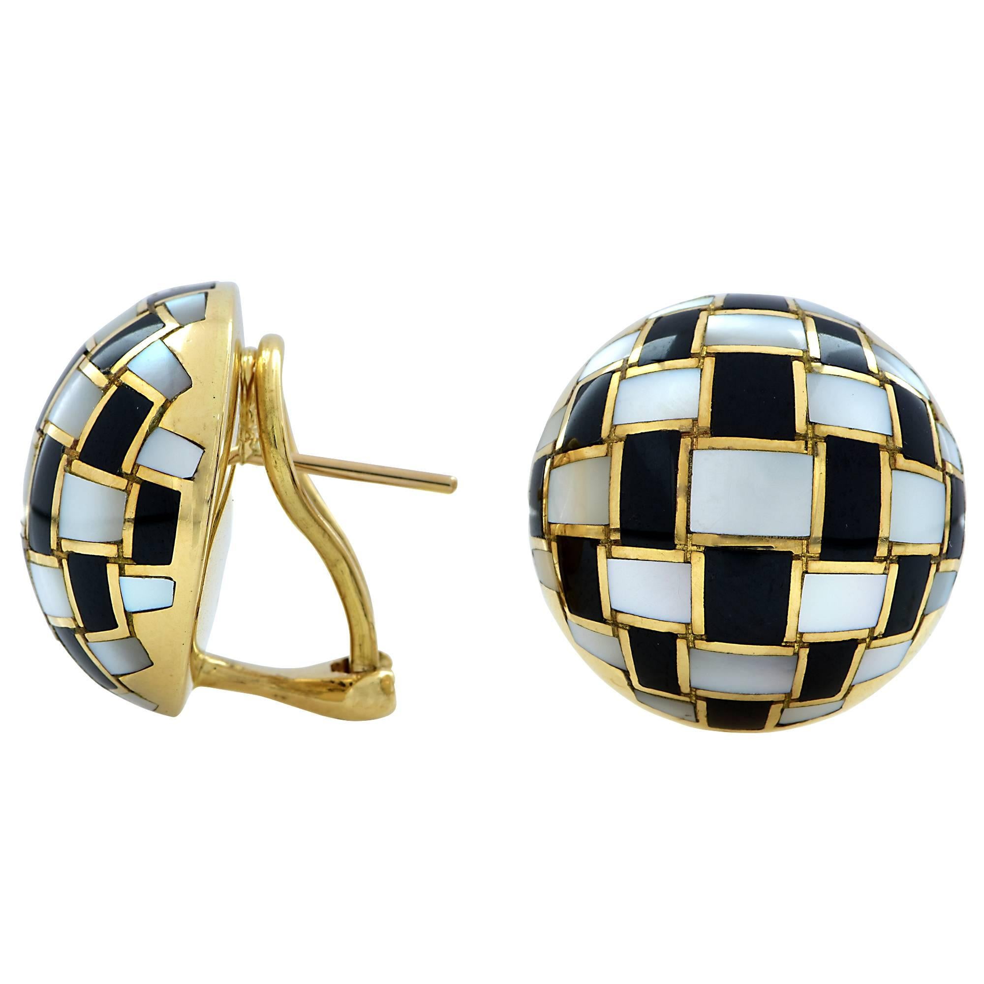 These fabulous 18k yellow gold Tiffany & Co. earrings are inlaid with mother of pearl and onyx in a checkerboard design.

The earrings measure .80 inch in height and width by .45 inch in depth not including clip-on.
It is stamped and/or tested