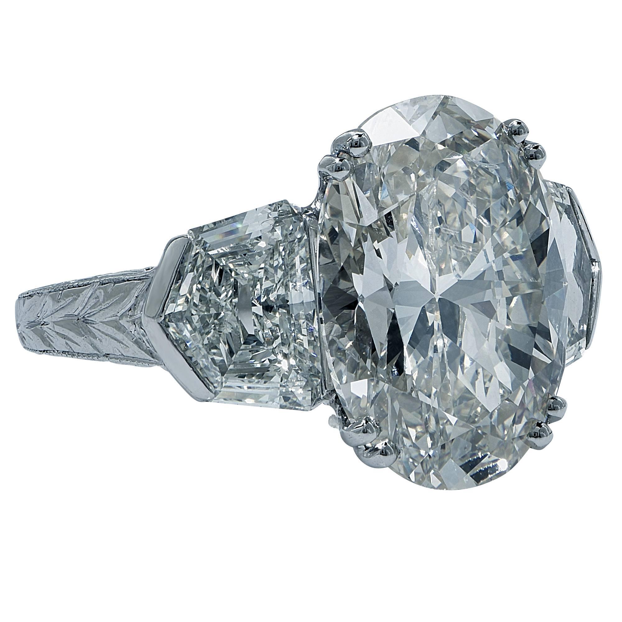 Platinum custom-made ring featuring a 7.52ct oval cut diamond I color I1 clarity, flanked by 2 shield cut diamonds weighing approximately 1.73cts total H color VS clarity.

The ring is a size 9 and can be sized up or down.
It is stamped and/or
