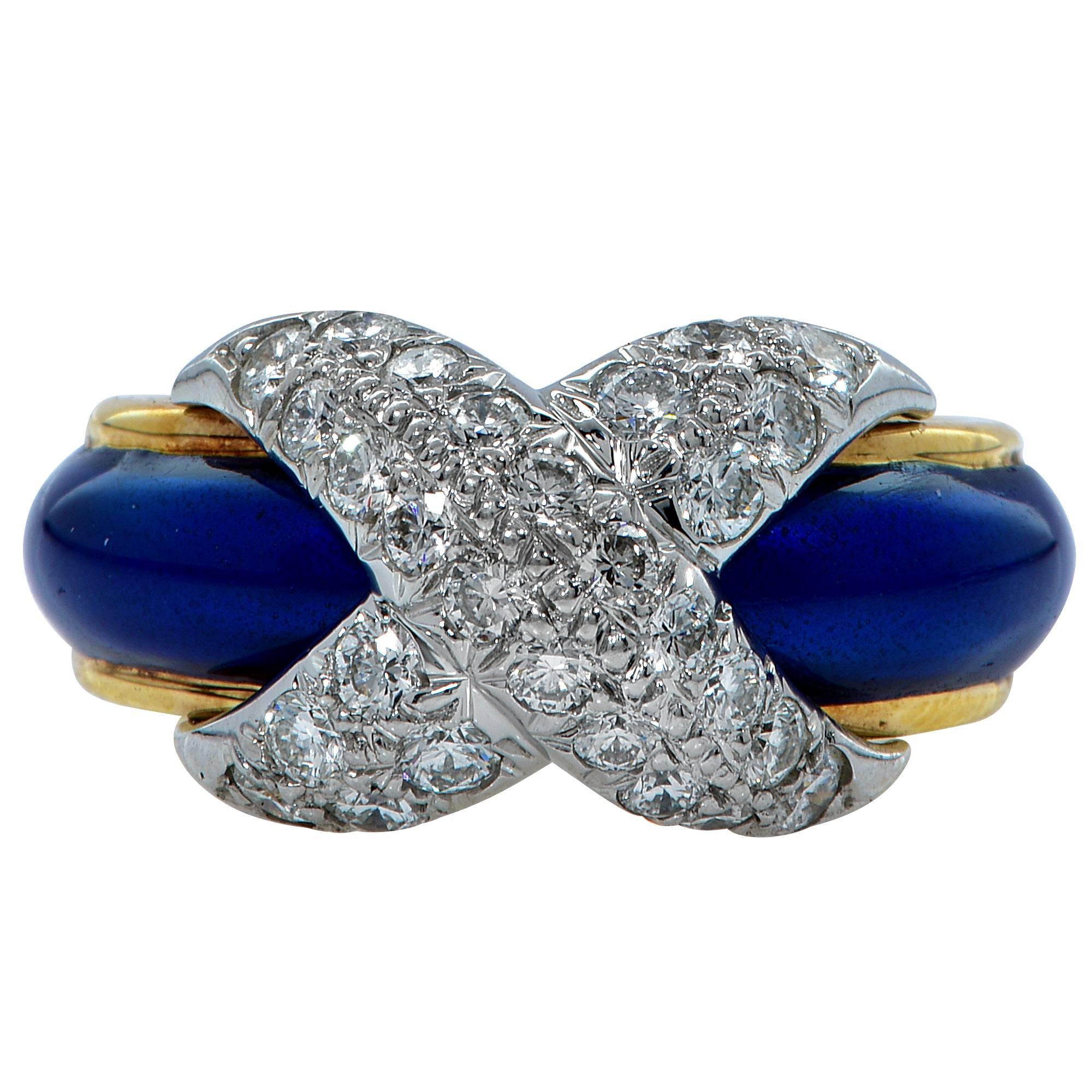 Tiffany & Co. Schlumberger X ring containing 28 round brilliant cut diamonds forming an X across the top of the ring and weighing approximately 1ct total, G-H color and VS clarity. The ring is further accented by a vibrant blue enamel band.

The