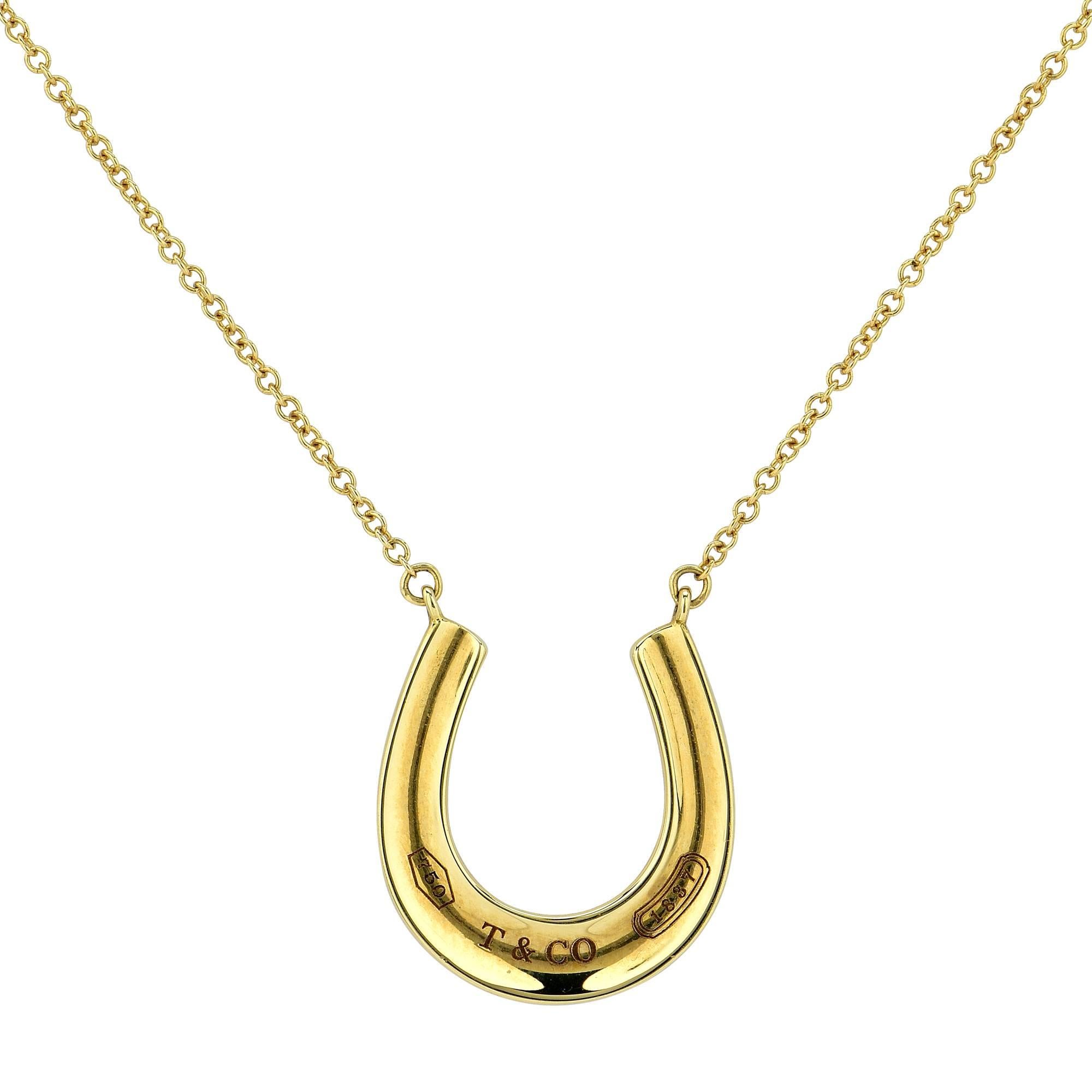 Tiffany & Co. 1837 horseshoe pendant and necklace crafted in 18k yellow gold.

The pendant measures 0.61 inch in width by 0.61 inch in height and is strung from an 18 inch chain.
It is stamped and/or tested as 18k gold.
This pendant weighs 3.74