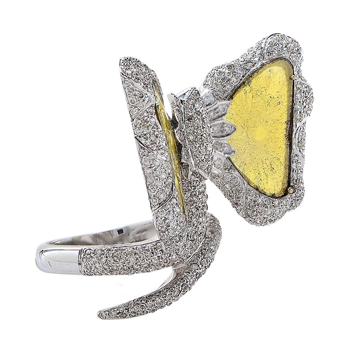 This beautiful diamond slice ring is crafted in 18k white gold and set with two natural yellow diamond slices surrounded by white round brilliant cut pave diamonds. The total diamond weight is 4.77cts.

The ring is a size 7 and cannot be sized.
It
