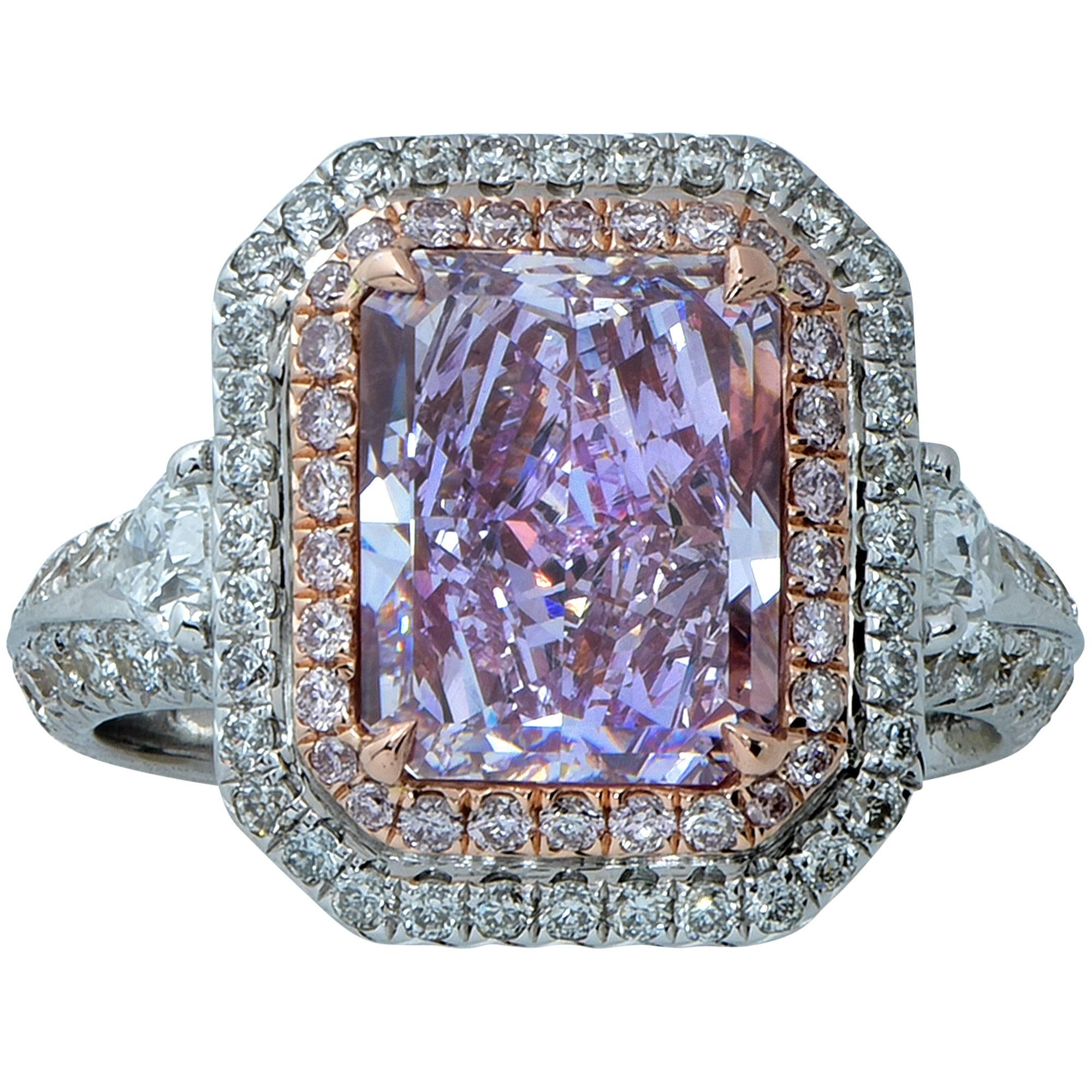 Alluring platinum and 18k rose gold engagement ring featuring a jaw dropping GIA graded 3.34ct natural fancy pinkish purple radiant cut diamond with a clarity grade of VS2. The center diamond is surrounded by 28 round brilliant cut pink diamonds