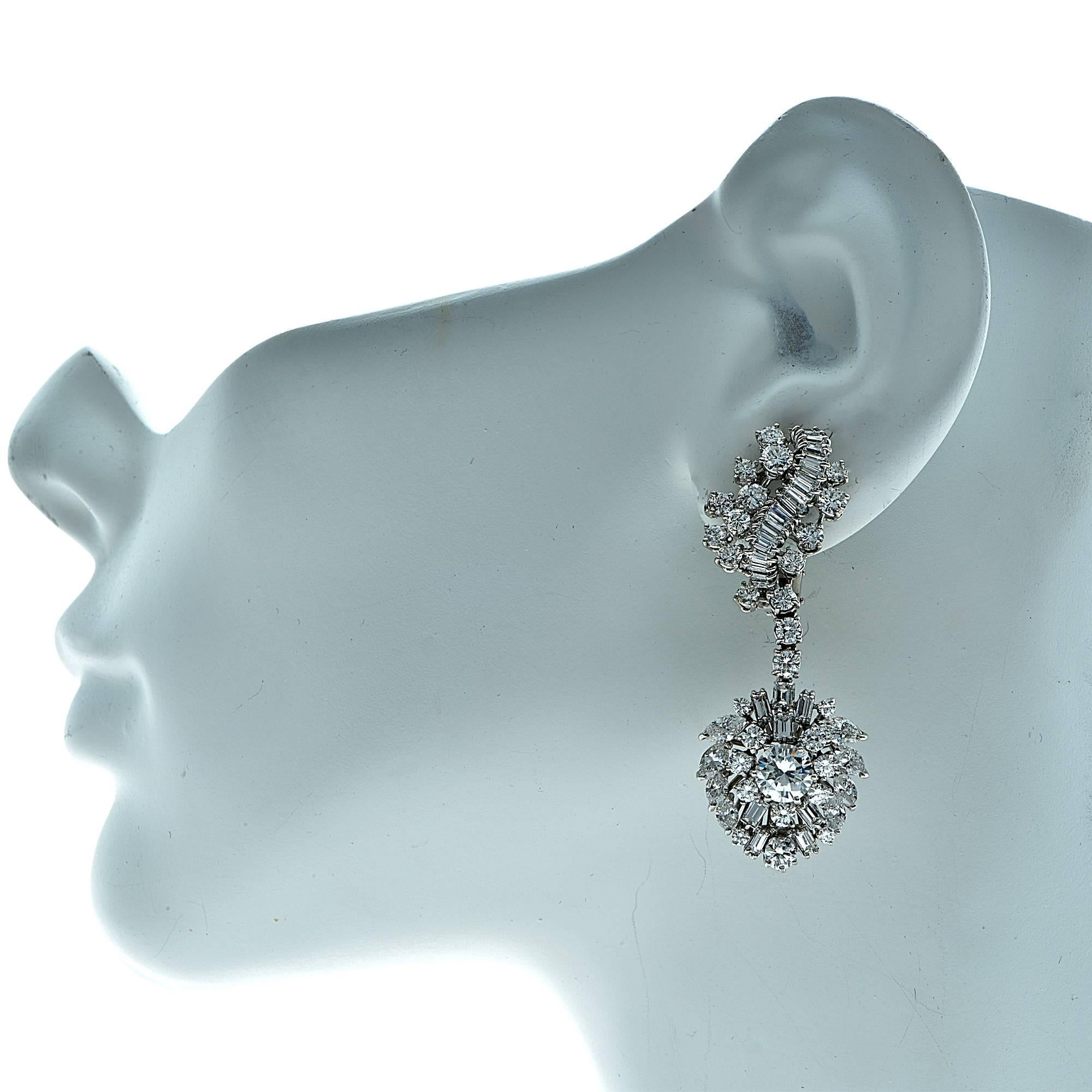 Platinum dangle earrings featuring 2 round brilliant cut diamonds weighing approximately 1.87cts total G-H color SI-I1 clarity accented by 124 round, baguette and marquise cut diamonds weighing approximately 10.30cts total G color VS