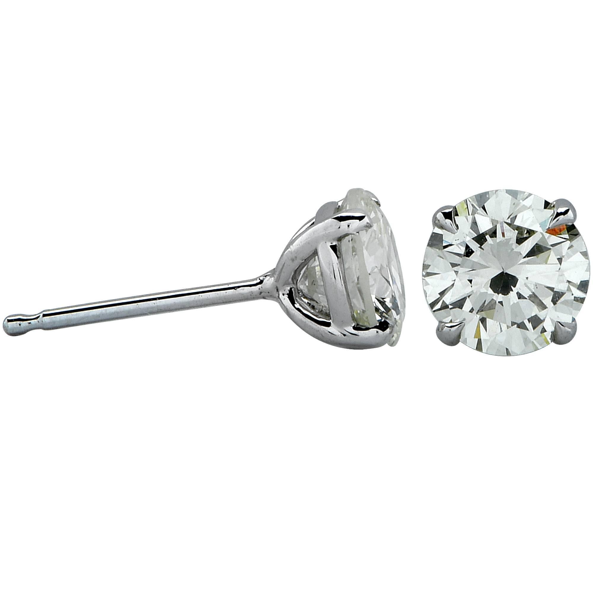 18k white gold 1.39 carat total weight diamond solitaire stud earrings featuring a matching .71ct round brilliant cut diamond L-M color and VS in clarity and .68ct round brilliant cut diamond L-M color and VS in clarity.

Measurements are available