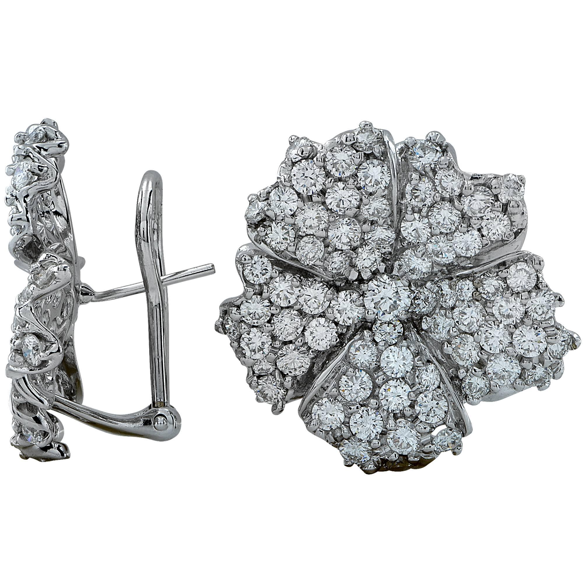 18k white gold flower motif earrings containing 138 round brilliant cut diamonds weighing approximately 7ct F color and VS clarity. These gorgeous earrings measure approximately 1 inch in diameter and are lever backs.

It is stamped and/or tested as