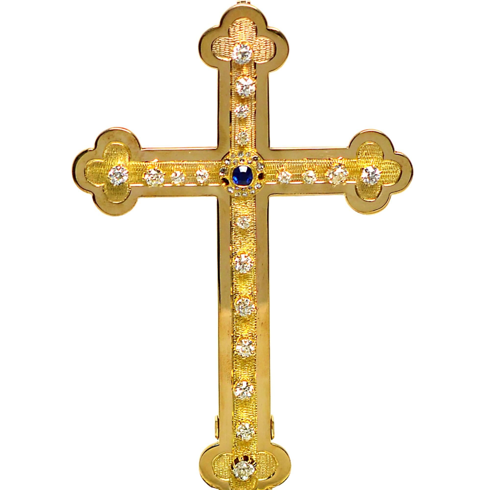 Unique 18k yellow gold cross featuring approximately 13.50cts of European, baguette and round brilliant cut diamonds fastened up top a 5900ct emerald base. The cross is removable and includes a bale to wear as a pendant. The cross measures 5 inches