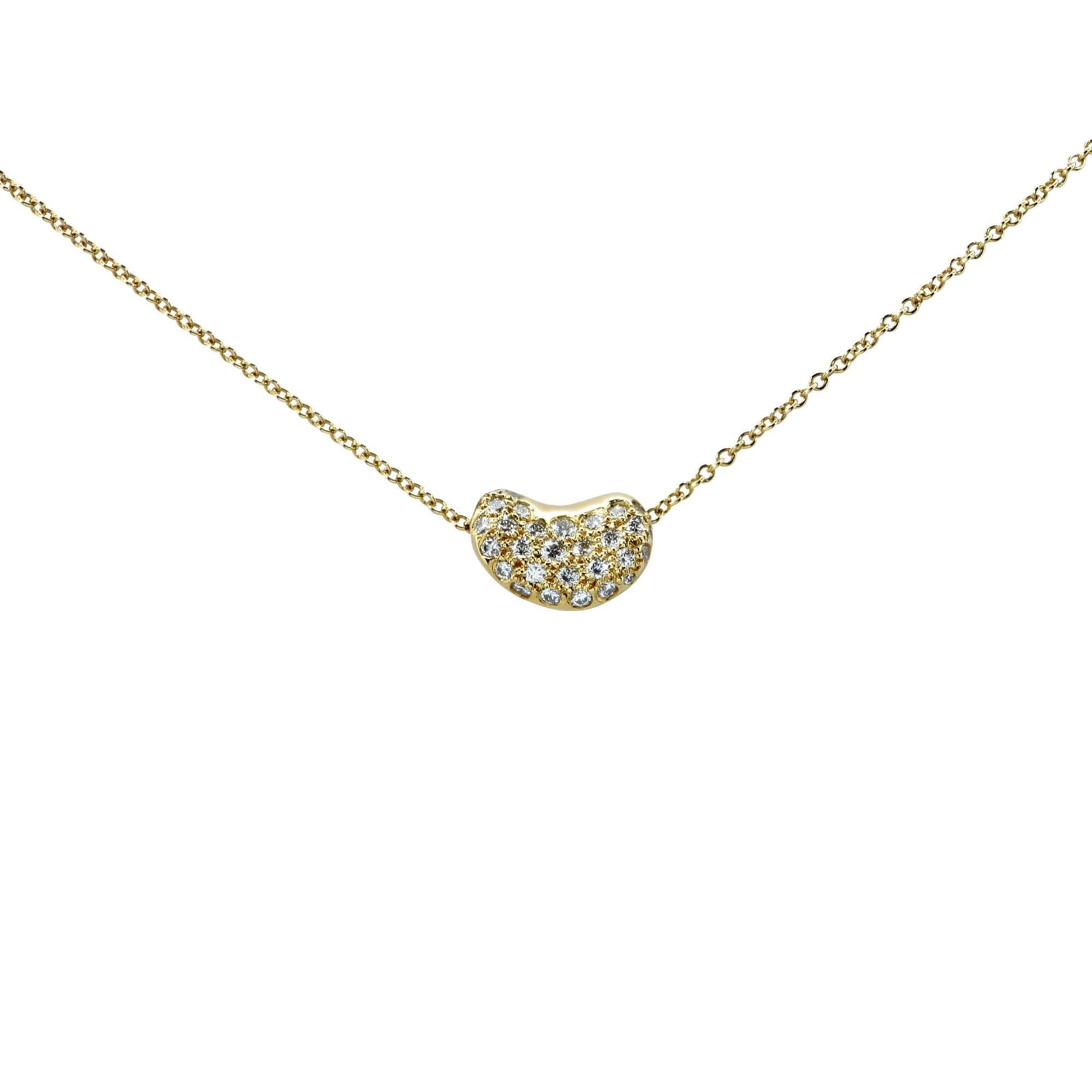 Tiffany & Co. Elsa Peretti bean necklace crafted in 18k yellow gold features .25cts of round brilliant cut diamonds, G color, VS clarity.

This necklace has a 16 inch chain with a pendant that measures 10.5mm in length by 7.5mm in width by 4.8mm in