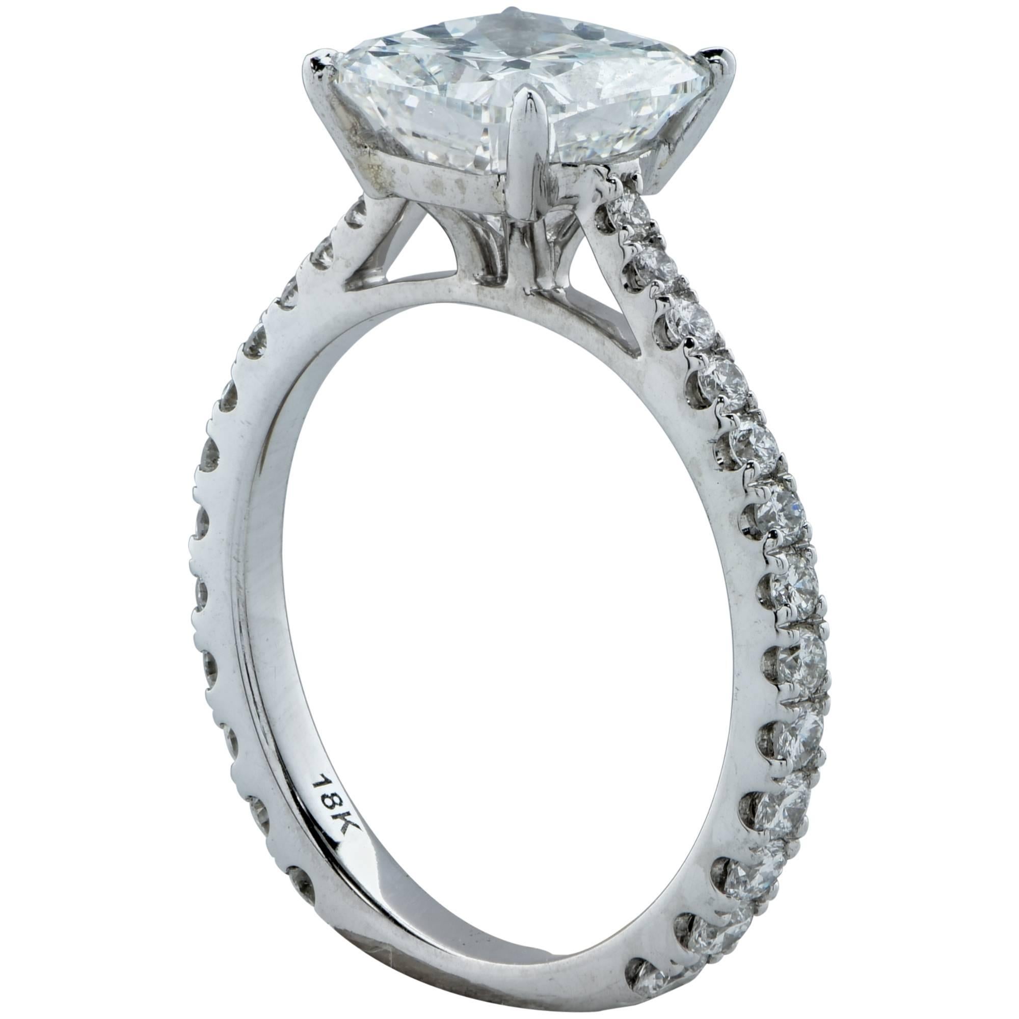 This beautiful 18k white gold engagement ring features a GIA graded 2.01ct F color SI1 clarity cushion cut diamond 100% eye clean with very good polish and symmetry. It is accented by 26 round brilliant cut diamonds weighing .50cts G color and VS