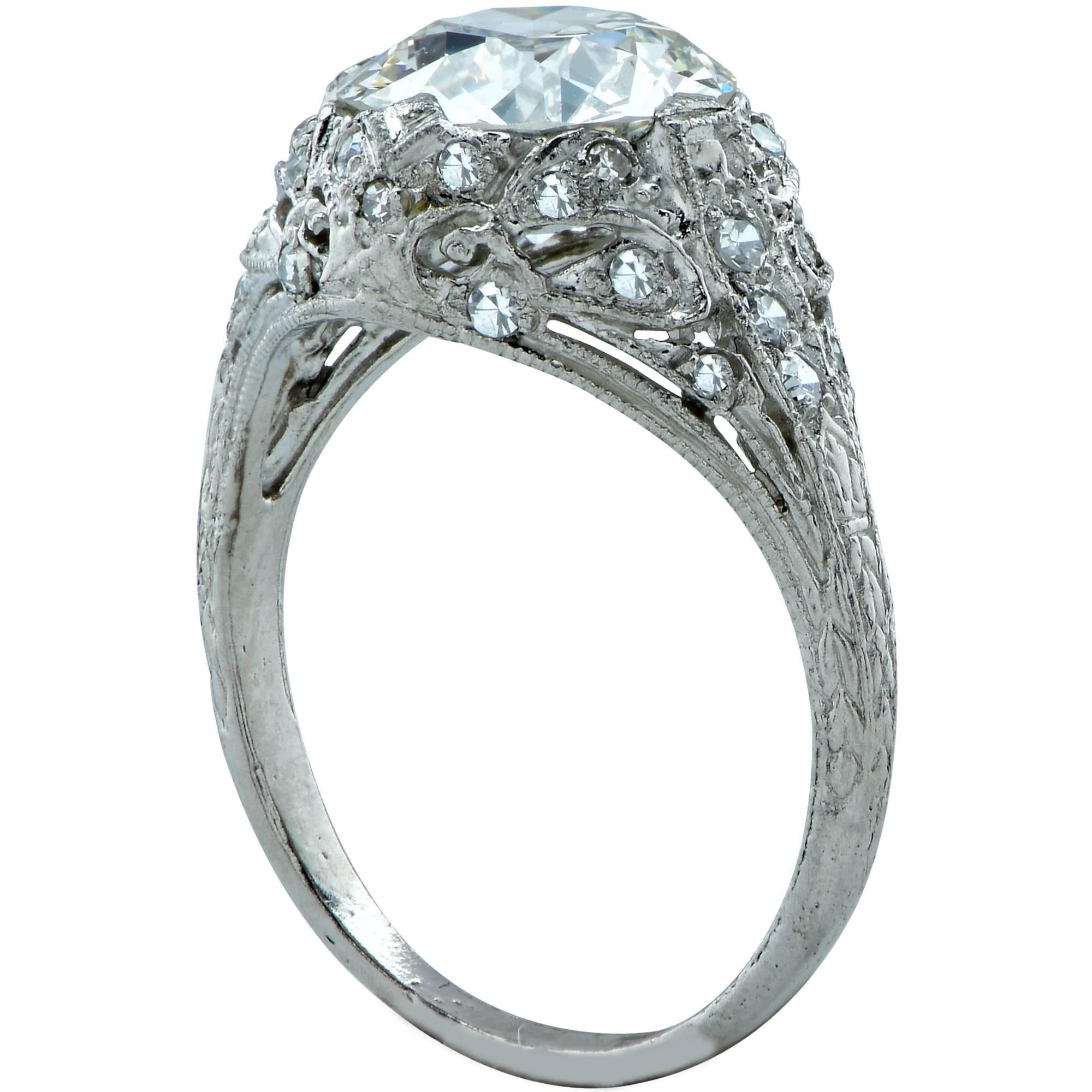 Platinum Art Deco ring showcasing a GIA graded 2ct European cut diamond J color and VS1 clarity surrounded by 32 single cut diamonds weighing approximately .50cts.

The ring is a size 5 and can be sized up or down.
Measurements are available upon