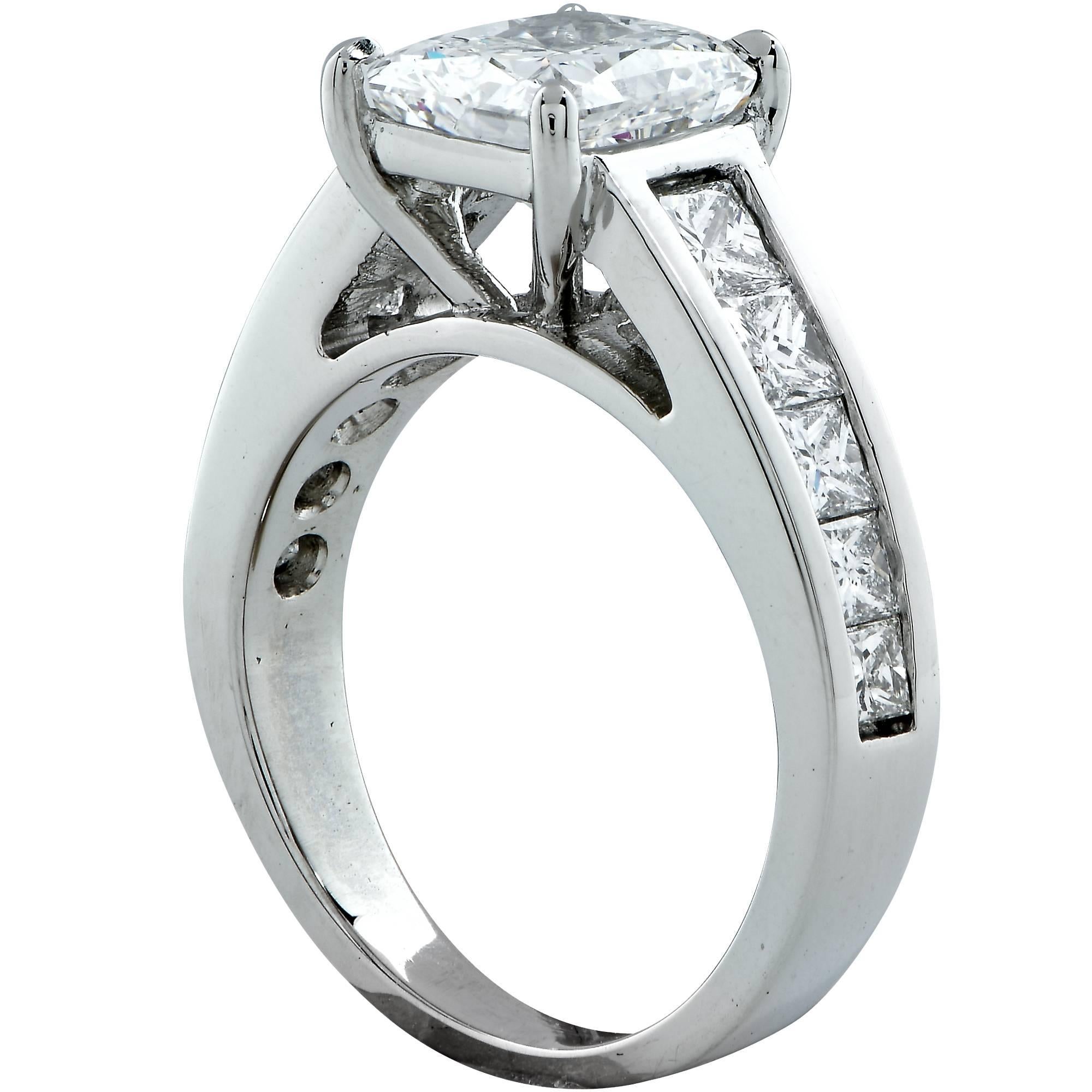 Platinum custom made ring featuring a GIA graded 2.01ct F color and SI2 clarity radiant cut diamond with excellent polish and very good symmetry. Flanked by 10 princess cut diamonds weighing approximately 1ct total F color and VS clarity. 

The ring