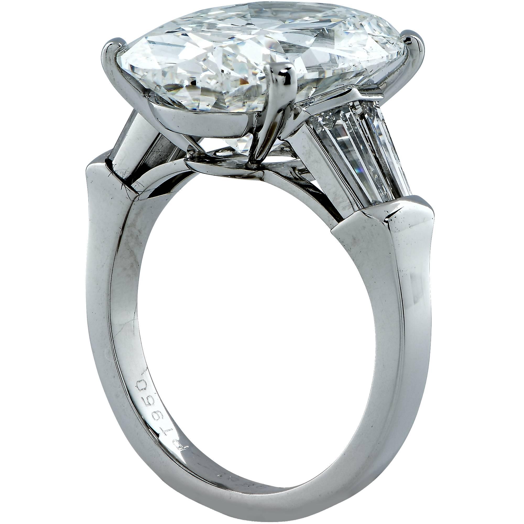This beautifully designed platinum custom made engagement ring will surely yield a smile. It highlights a GIA graded 9.48ct oval cut diamond I color and SI1 clarity and is flanked by 4 tapered baguettes weighing approximately 1.20ct total H color