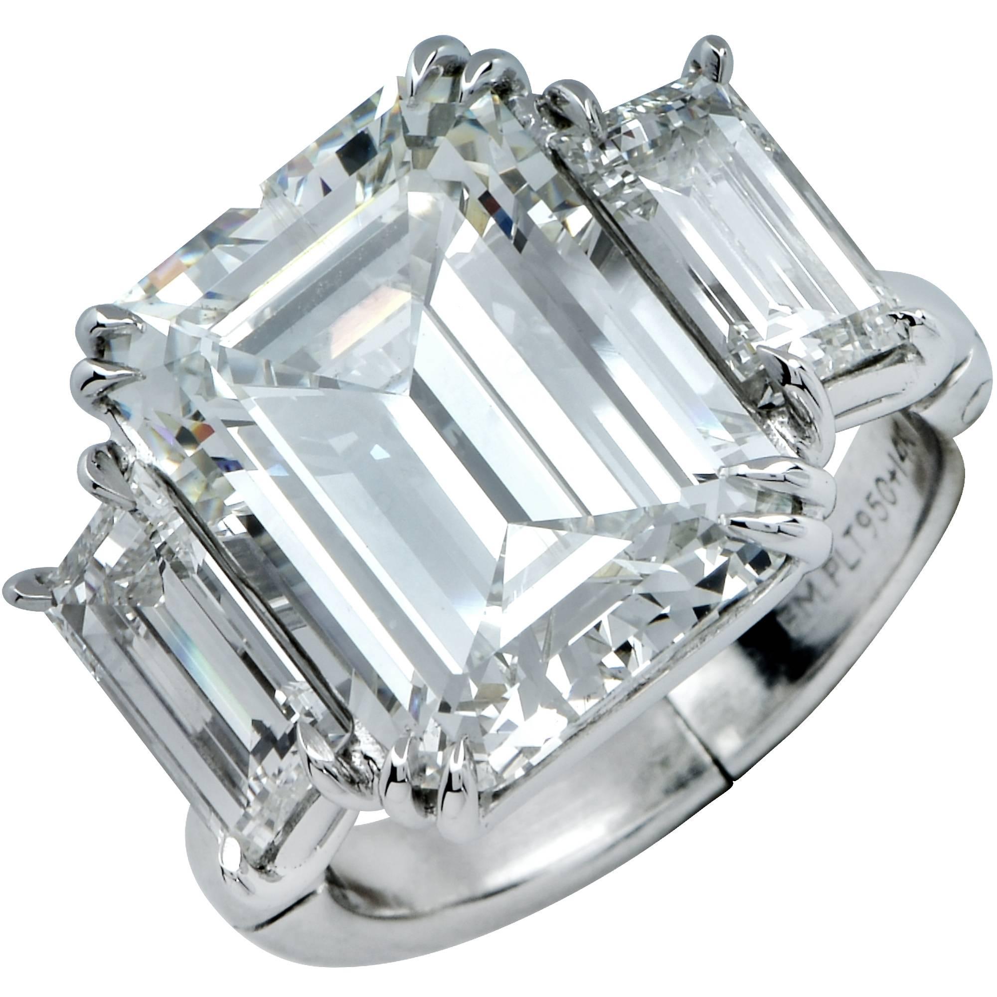 This stunning platinum handmade engagement ring boasts a spectacular GIA graded 7.98ct emerald cut diamond J color and SI2 clarity which is 100% eye clean. It is flanked by 2 long baguette cut diamonds weighing 2.08ct total I color and VS clarity.