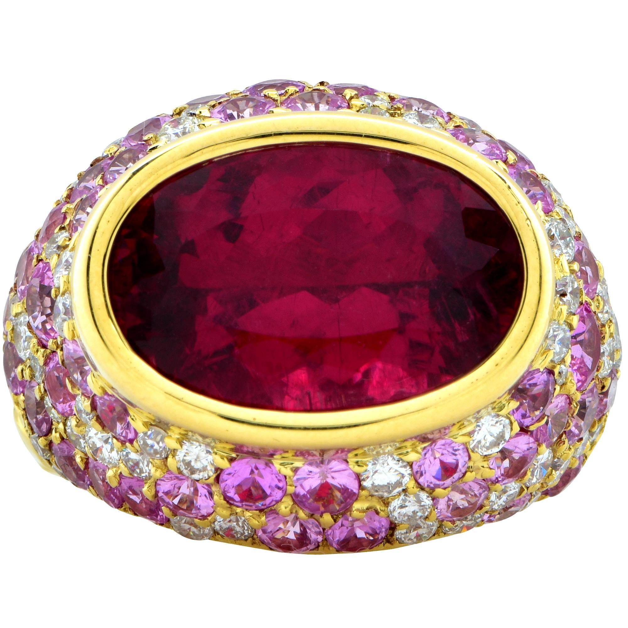 Beautiful 18k yellow gold bombe ring featuring a rubellite tourmaline weighing approximately 8cts accented by 52 round brilliant cut diamonds weighing approximately 1.50cts total, G color, VS-SI clarity.

The face of the ring measures 25mm x 19.3mm