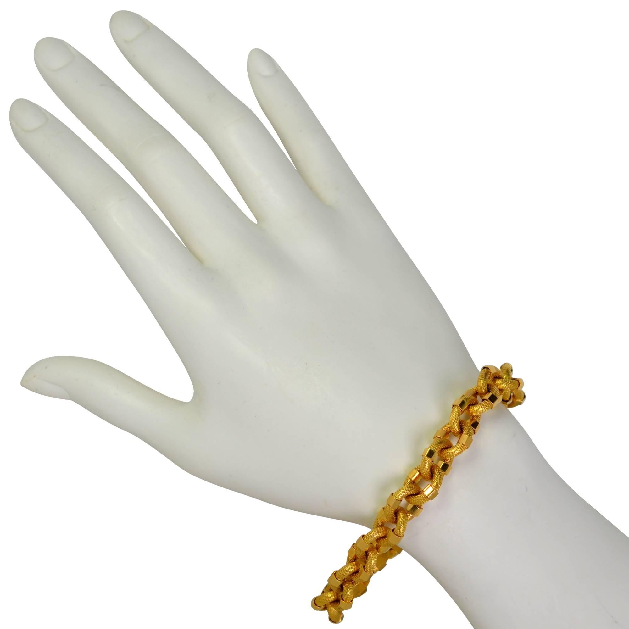18k yellow gold bracelet featuring textured links accented with high polish hexagonal gold bolts.

This modernistic bracelet measures 8.5 inches in length by .5 inches in width.
It is stamped and/or tested as 18k gold.
The metal weight is 23.32