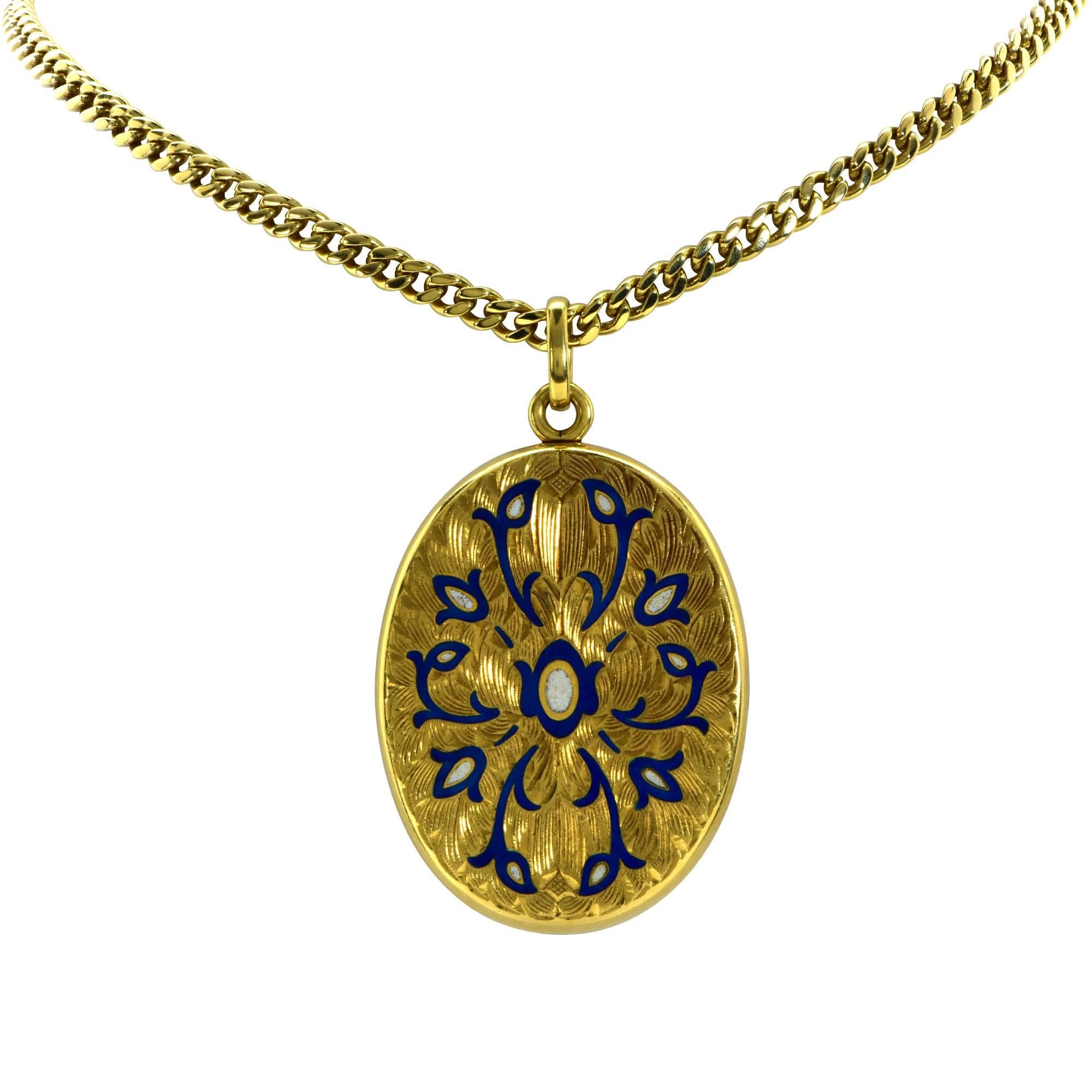 18k yellow gold pendant locket accented by fine engraving as well as blue and white enamel.

The chain measures 24 inches long and the locket measures 1.75 inches in height by 1.35 inches in width.
It is stamped and/or tested as 18k gold.
The metal