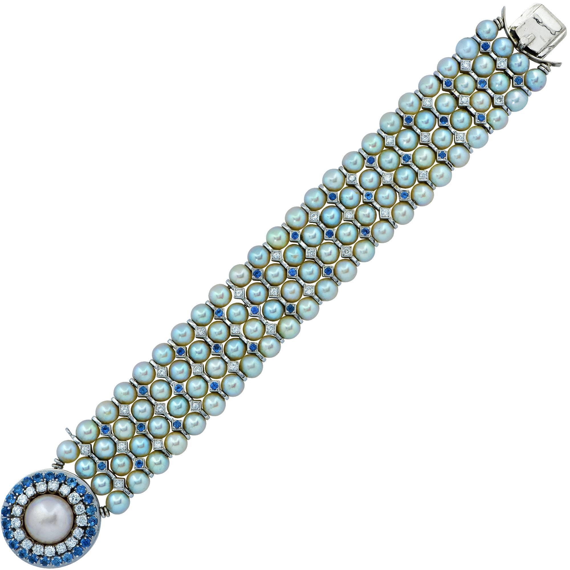 White gold bracelet featuring 92 round pearls measuring 6mm accented by 50 round brilliant cut diamonds weighing approximately 1.50cts and and 56 sapphires weighing approximately 1.80cts.

The bracelet measures 7.25 inches in length by 1 inch in