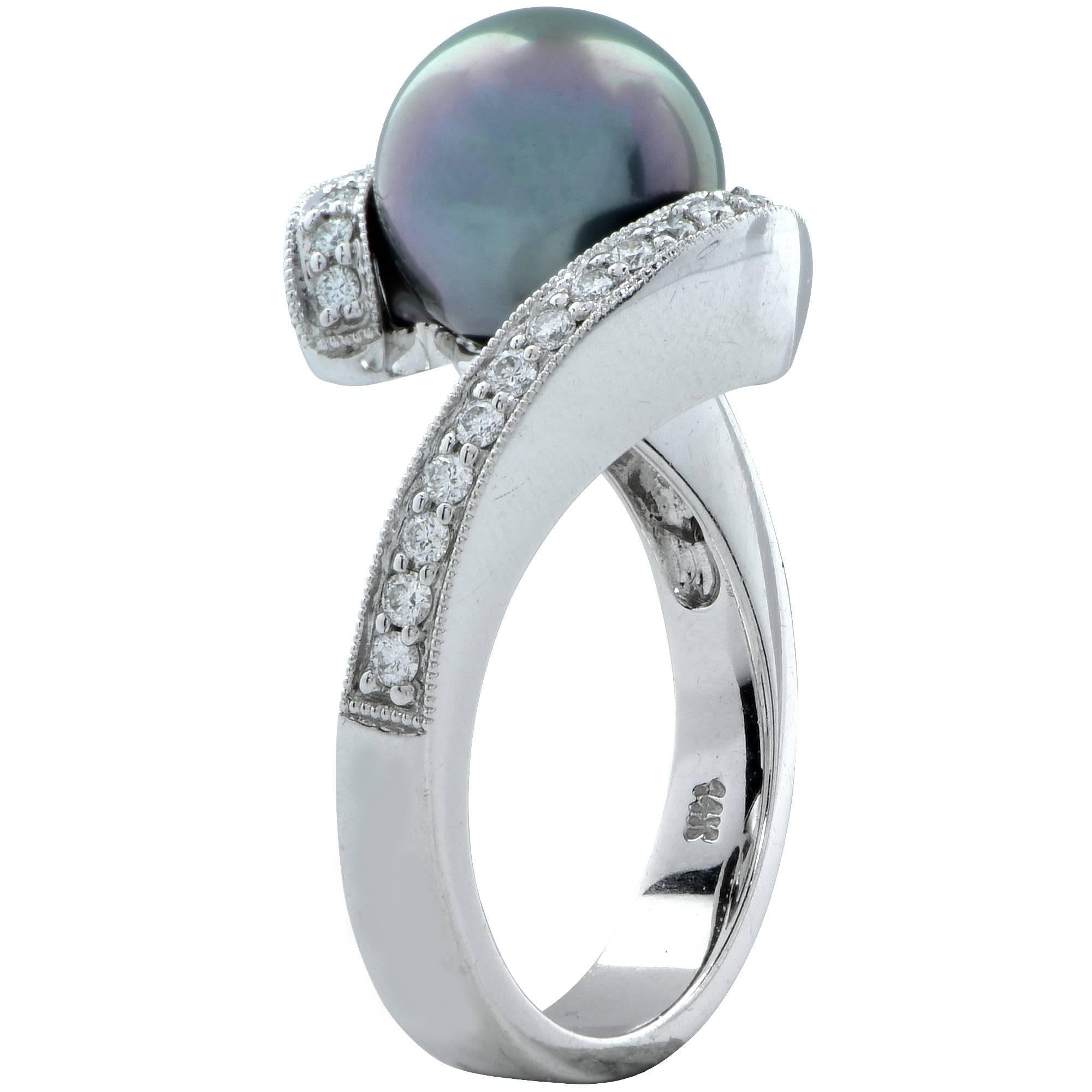 14k white gold ring featuring a 9.4mm Tahitian pearl and accented by 30 round brilliant cut diamonds weighing approximately .30cts.

The ring is a size 7 and can be sized up or down.
Measurements are available upon request.
It is stamped and/or