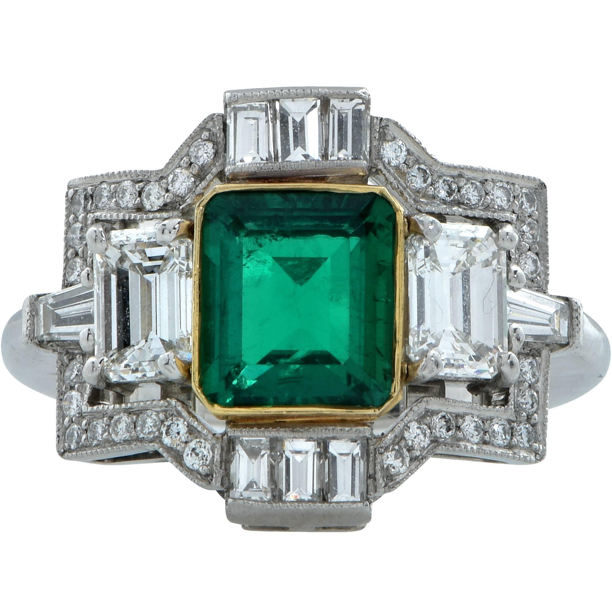 Platinum and 18k yellow gold ring featuring an emerald cut emerald from Colombia weighing approximately 1.50cts. Flanked by 2 emerald cut diamonds weighing 1ct total, G color VS clarity, accented by approximately .55cts total G color VS