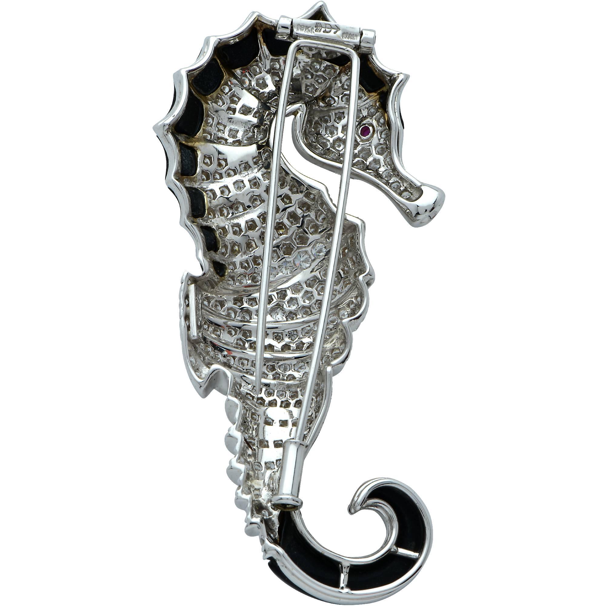 Whimsical seahorse finely crafted in 18k white gold, adorned with onyx and approximately 4.50cts of spectacular round brilliant cut diamonds G color VS1-2 clarity. This beautiful sea horse features remarkable craftsmanship and measures approximately