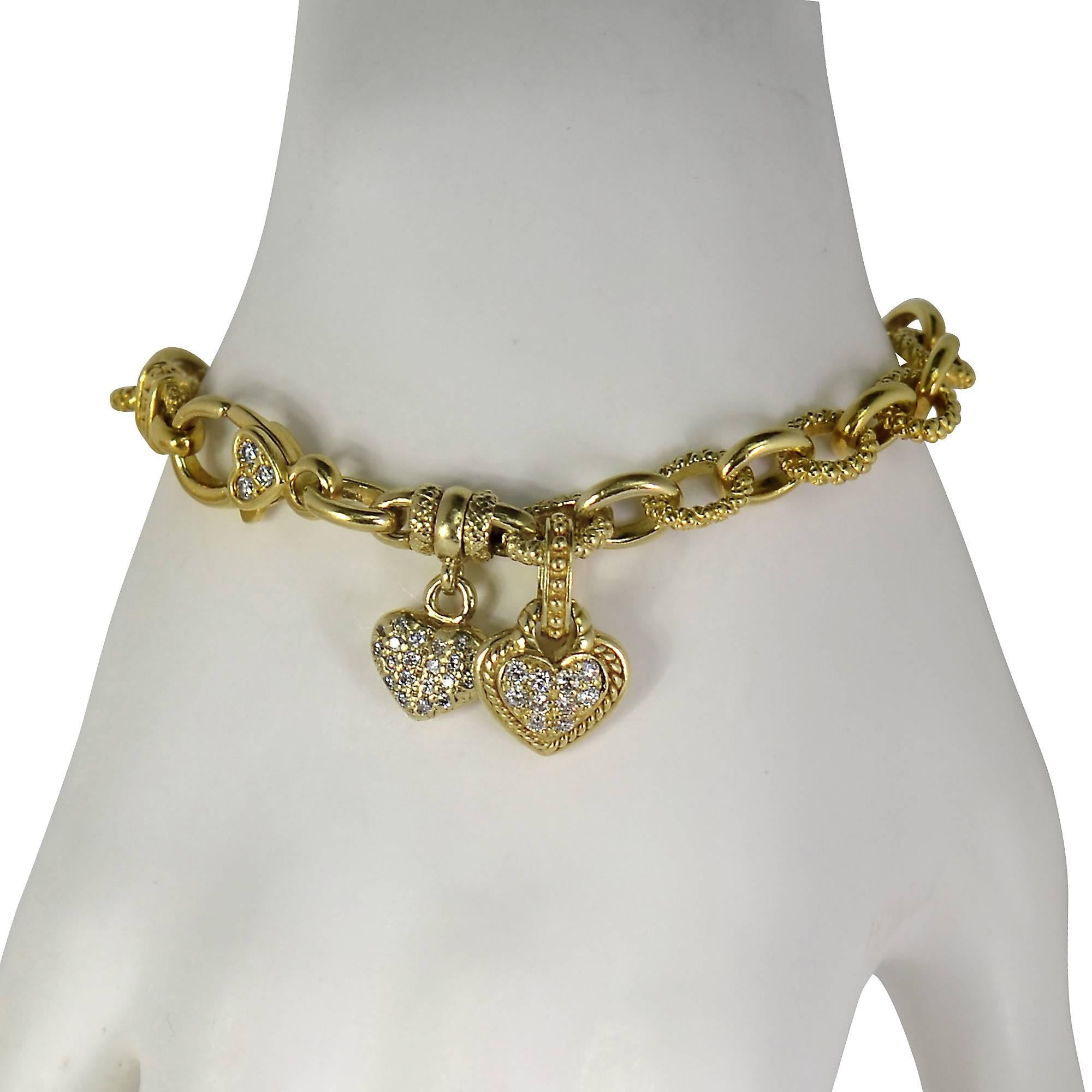 Fabulous Judith Ripka diamond bracelet crafted in 18k yellow gold featuring 33 round brilliant cut diamonds weighing approximately .75cts total, G color, VS-SI clarity. The bracelet is adorned with hearts studded with diamonds further accented by