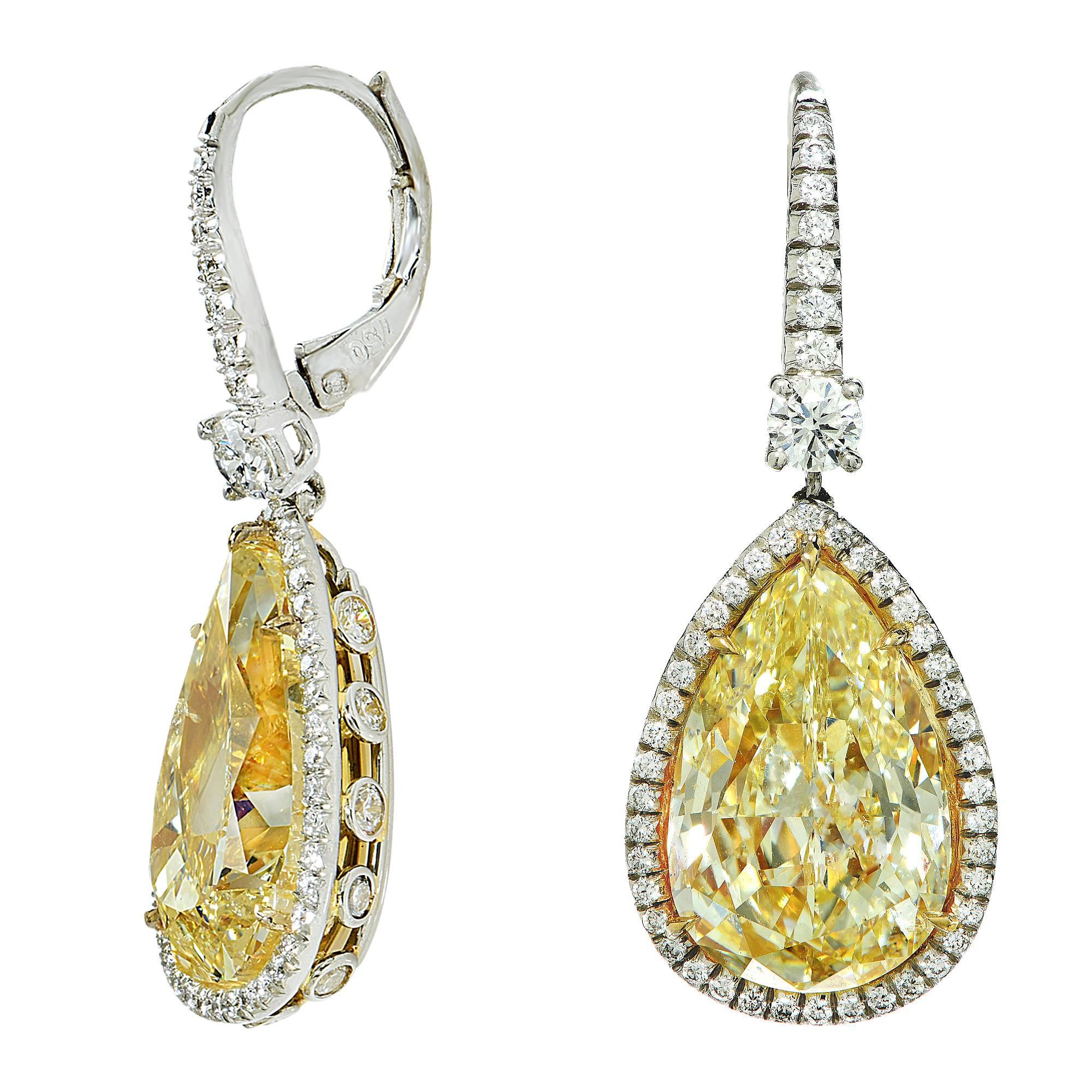 These elegant platinum earrings feature 2 fancy light yellow pear shape diamonds weighing 14.49cts total and are accented by 76 round brilliant cut diamonds weighing .90ct, G color, VS clarity.

These yellow diamond earrings are accompanied by a
