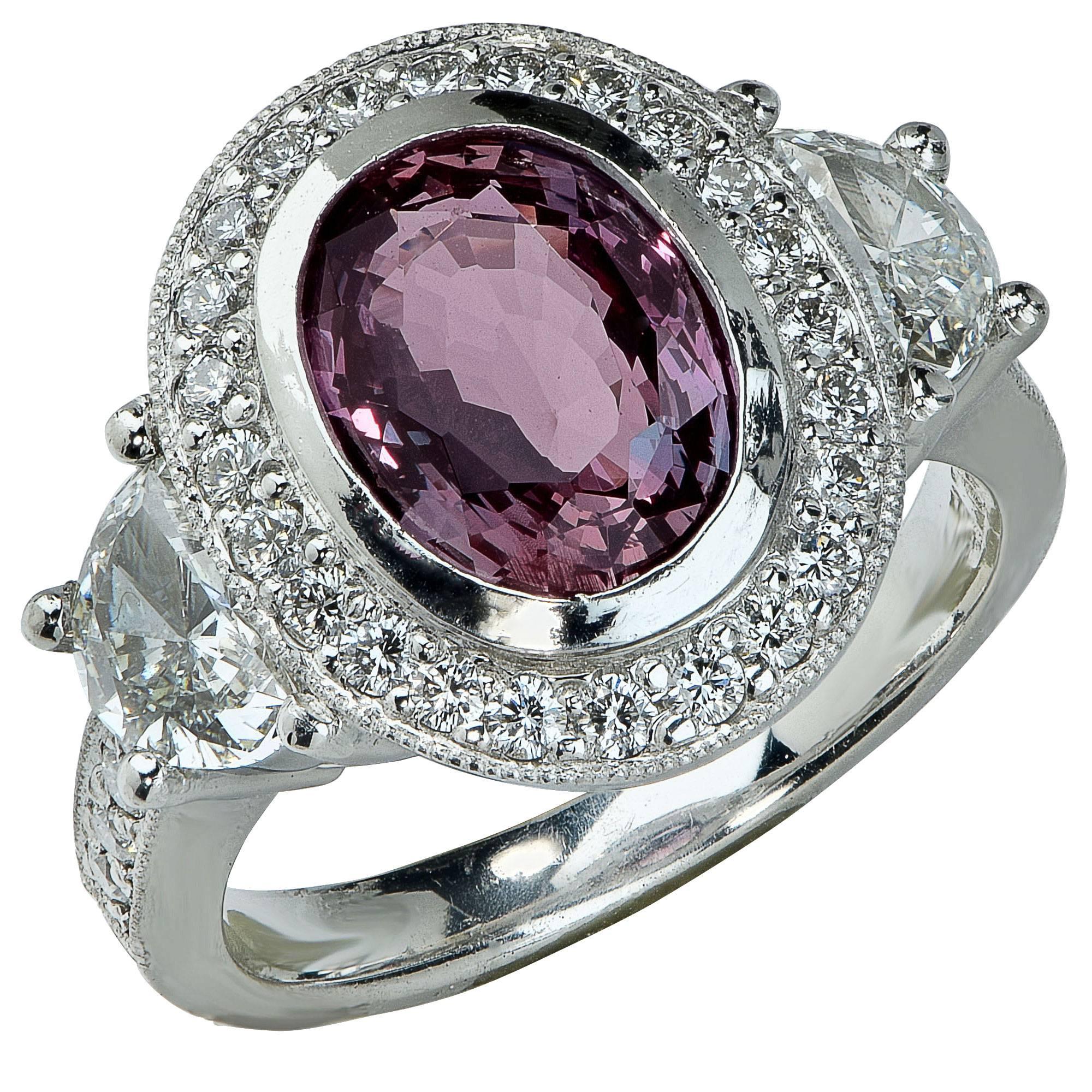 Platinum Ring Set with 2.88ct Alexandrite Flanked by 2 Half Moon Shaped Diamonds Weighing Approximately .84cts Surrounded by 32 Round Brilliant Diamonds Weighing Approximately .50cts.