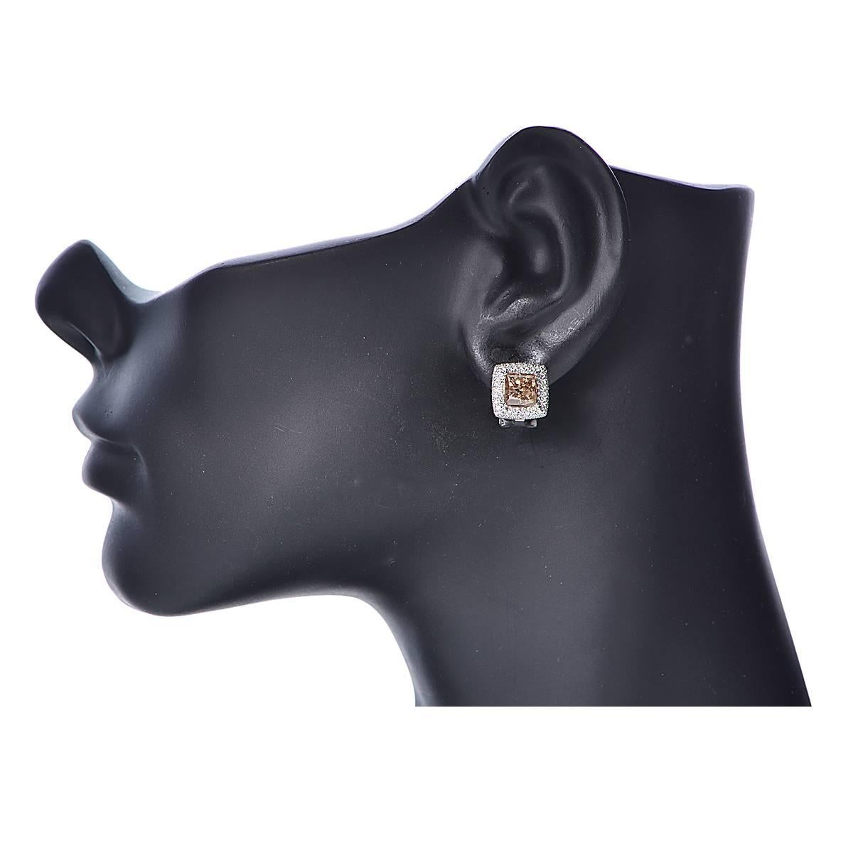 18 Karat White Gold and Diamond Earrings Featuring 2 Princess Cut Brown Diamonds Weighing Approximately 3.79cts, SI2 Clarity, Accented by 168 Round Brilliant Cut Diamonds Weighing Approximately .70cts. Total Diamond Weight is 4.49cts.
