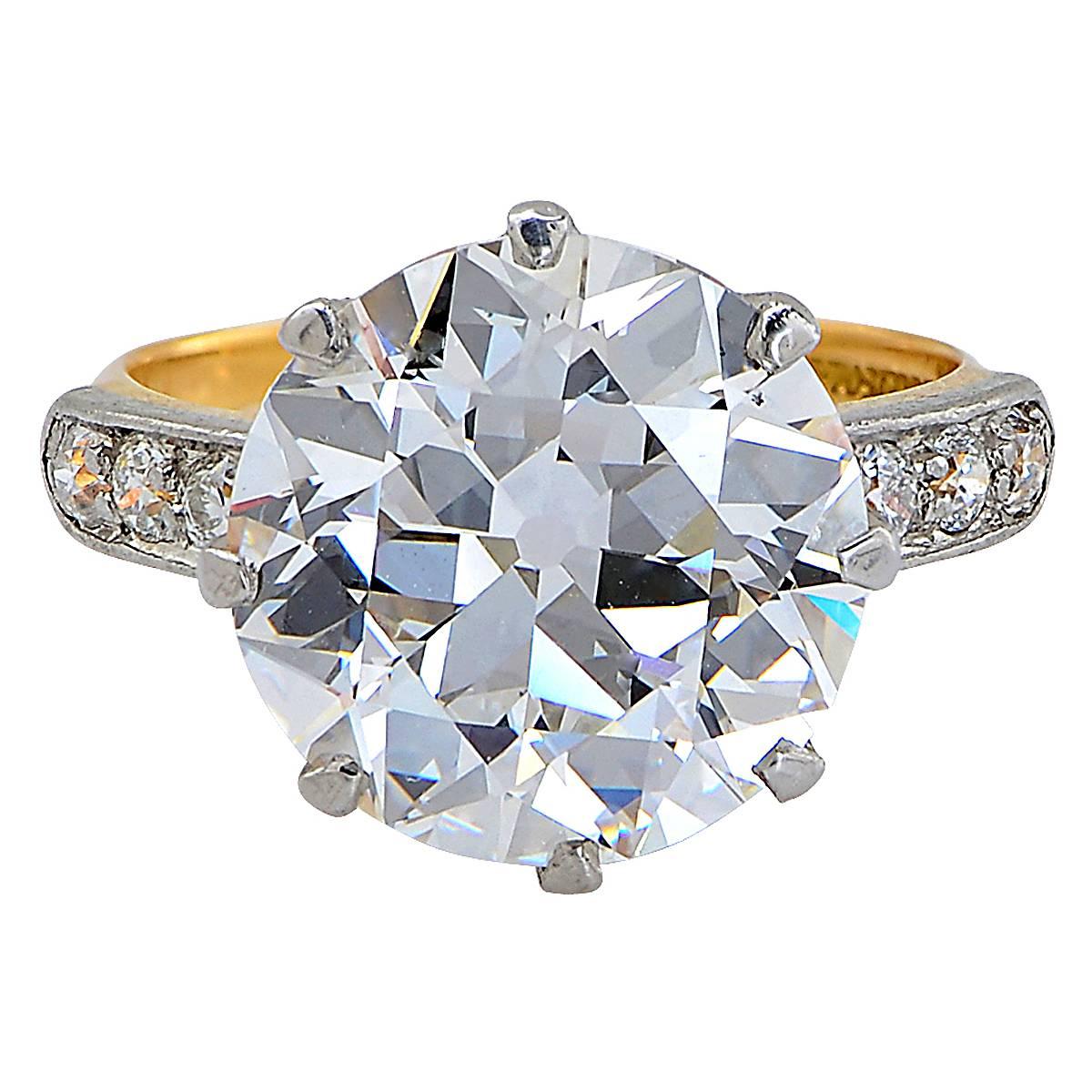 Tiffany & Co. Platinum Over Gold Ring Containing a 6.40ct, G Color, VVS2 Clarity, GIA Graded Old European Cut Diamond Flanked by 6 Old European Cut Diamonds Appoximately .10cts, F Color, VS Clarity - Circa 1920's. The Ring Size is Currently 5 but
