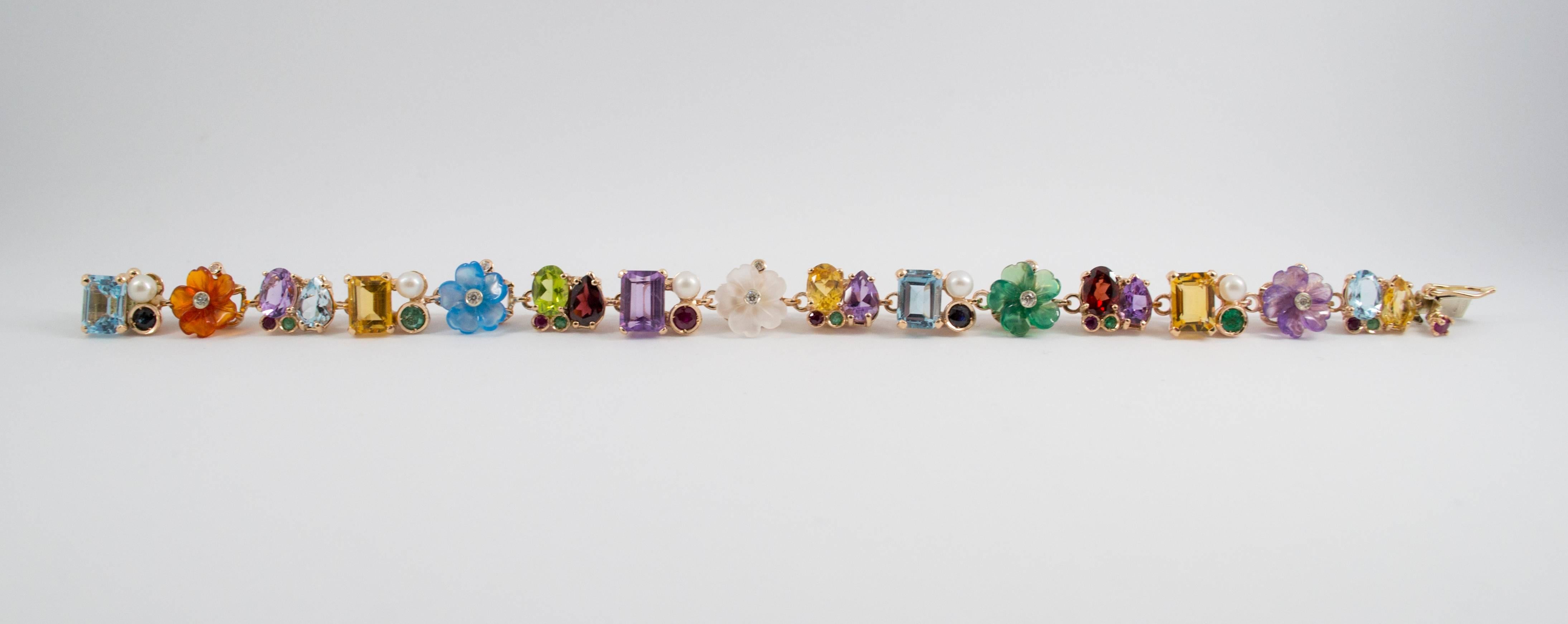 This bracelet is made of 14k Yellow Gold. 
This bracelet has 0.80 Carats of Rubies, Emeralds and Sapphires. 
This bracelet has 0.20 Carats of Diamonds. 
This bracelet has also Rock Crystal, Agate, Carnelian, Pearl, Peridot, Amethyst, Citrine, Topaz