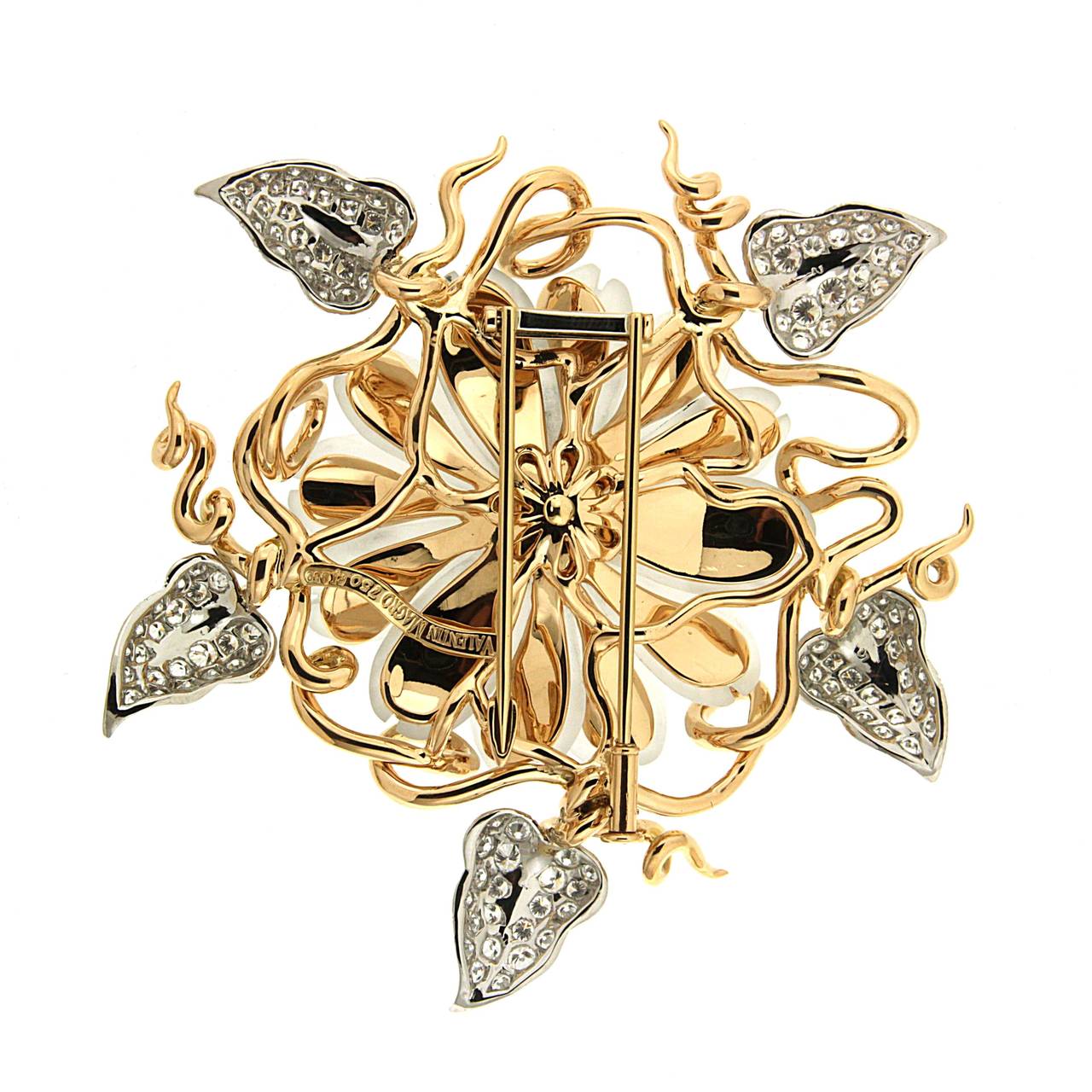 Elegant Flower brooch featuring hand carved crystal, featured with round brilliant diamonds set on the leaves and gold veins. This brooch is made in 18kt yellow gold.