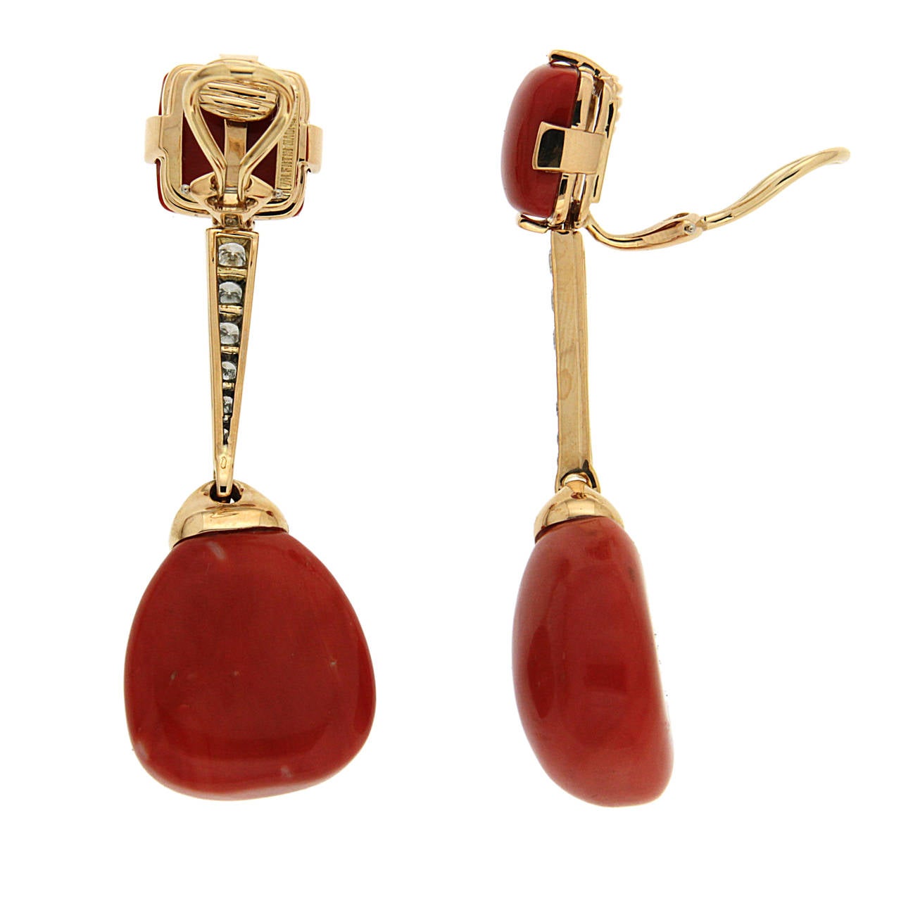 This pair of clip earrings is made with top quality red coral cushion cabochons on the top and Sardinian corals drops, linked with tapered pave diamonds.  
18K Yellow Gold