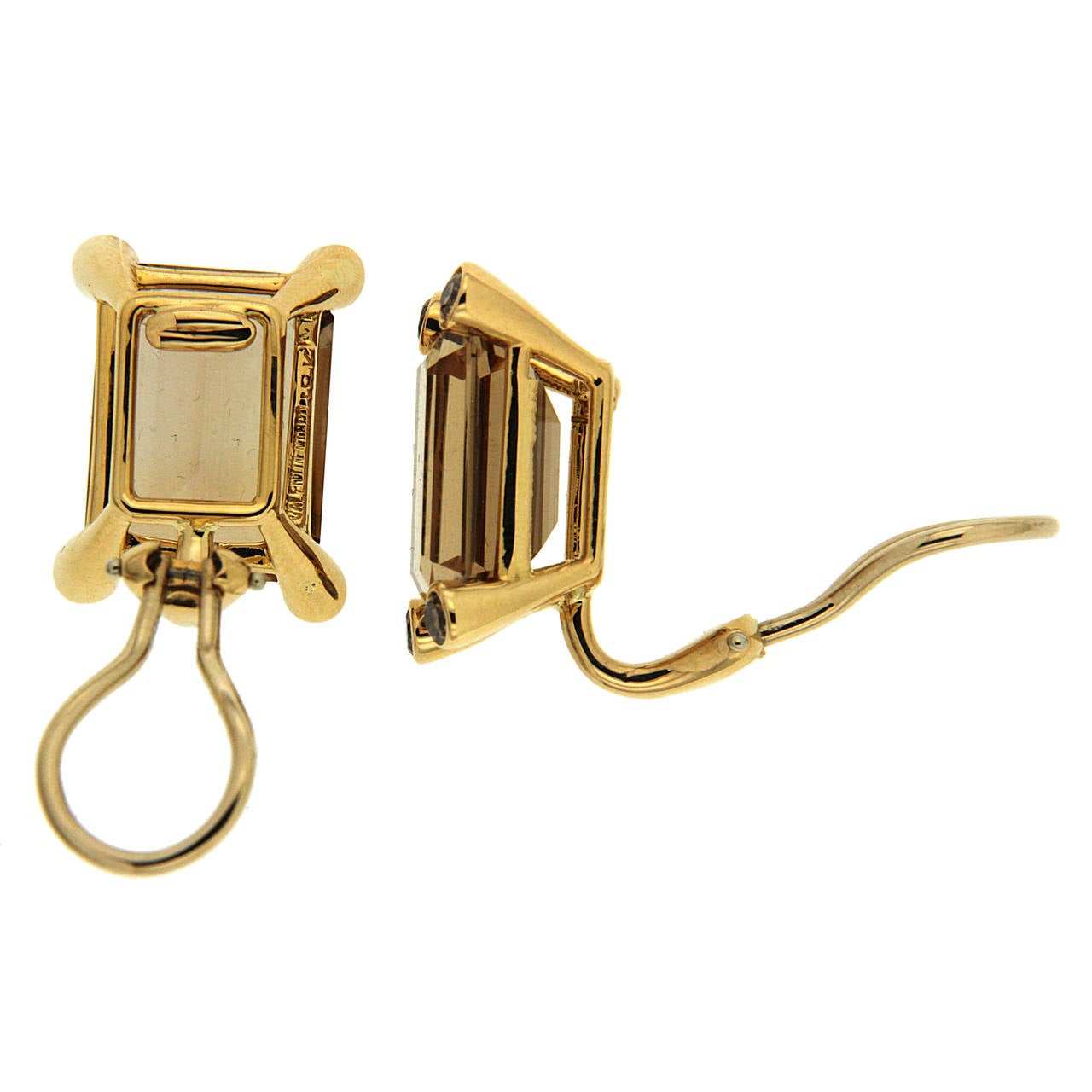 This pair of E.C. topaz and brown diamonds earrings is made in 18kt. Yellow Gold with Clip backs. Posts can be added upon request. Modern and Chic, emerald cut topaz and brown diamonds add sophistication, and depth to your outfits. 