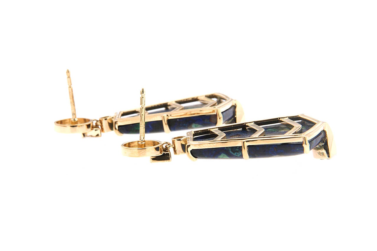 The earrings are made in 18kt yellow gold with Azurite Malachite, they are designed with geometric motifs of square and circle tops. These earrings are finished with diamonds and posts.