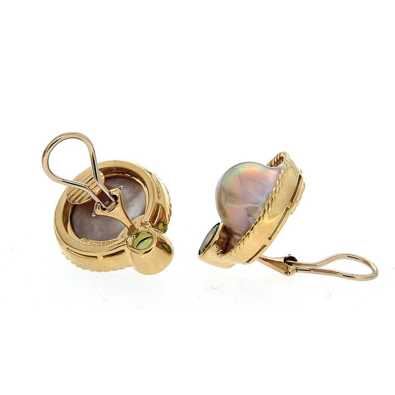 These earrings are made in 18kt yellow gold, they feature a round faceted peridot and baroque pearl blisters, the backs on these earrings are clip-backs.