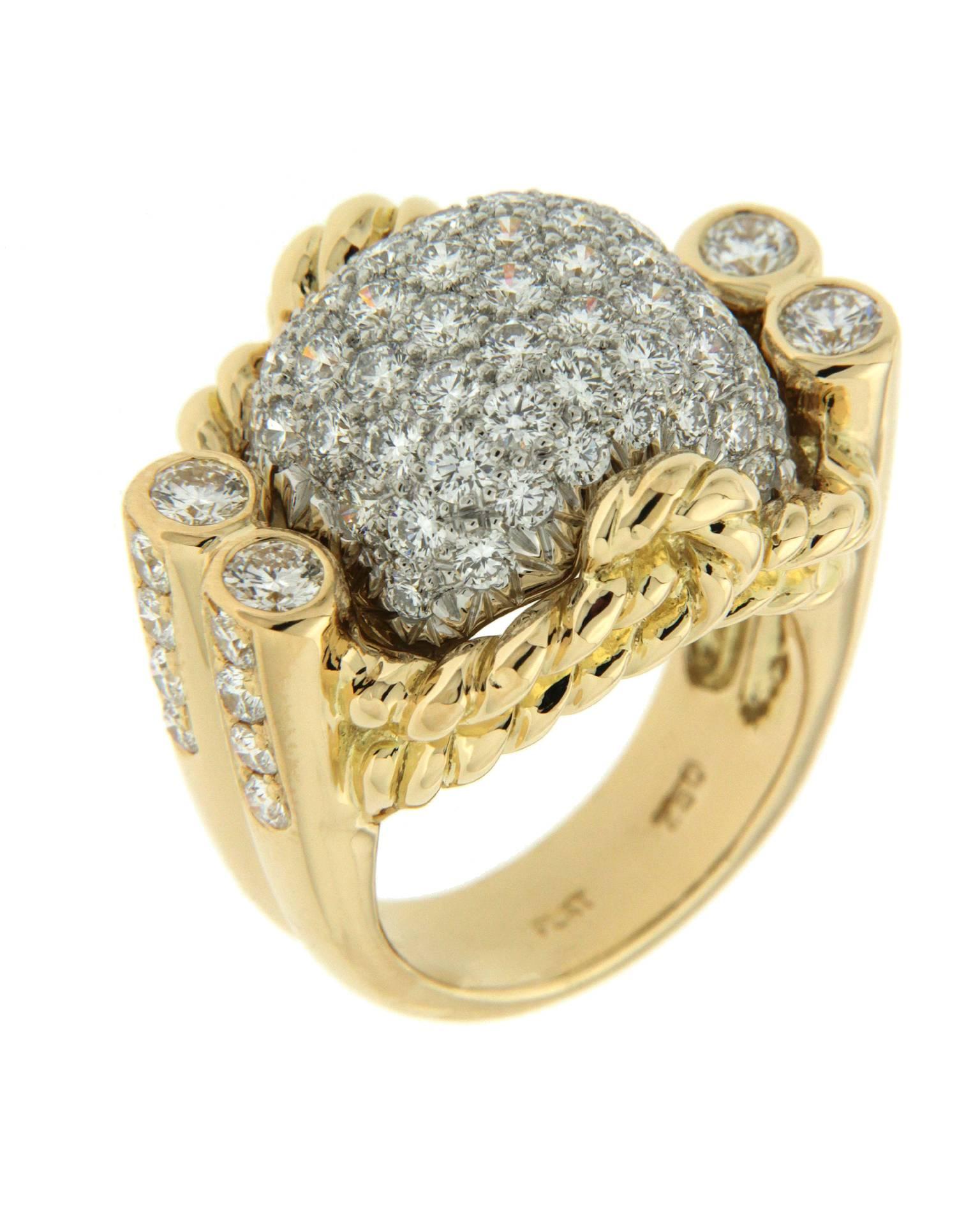 The ring is made in 18kt yellow gold and platinum.  It features round brilliant diamonds with a carat total weight of 3.60.