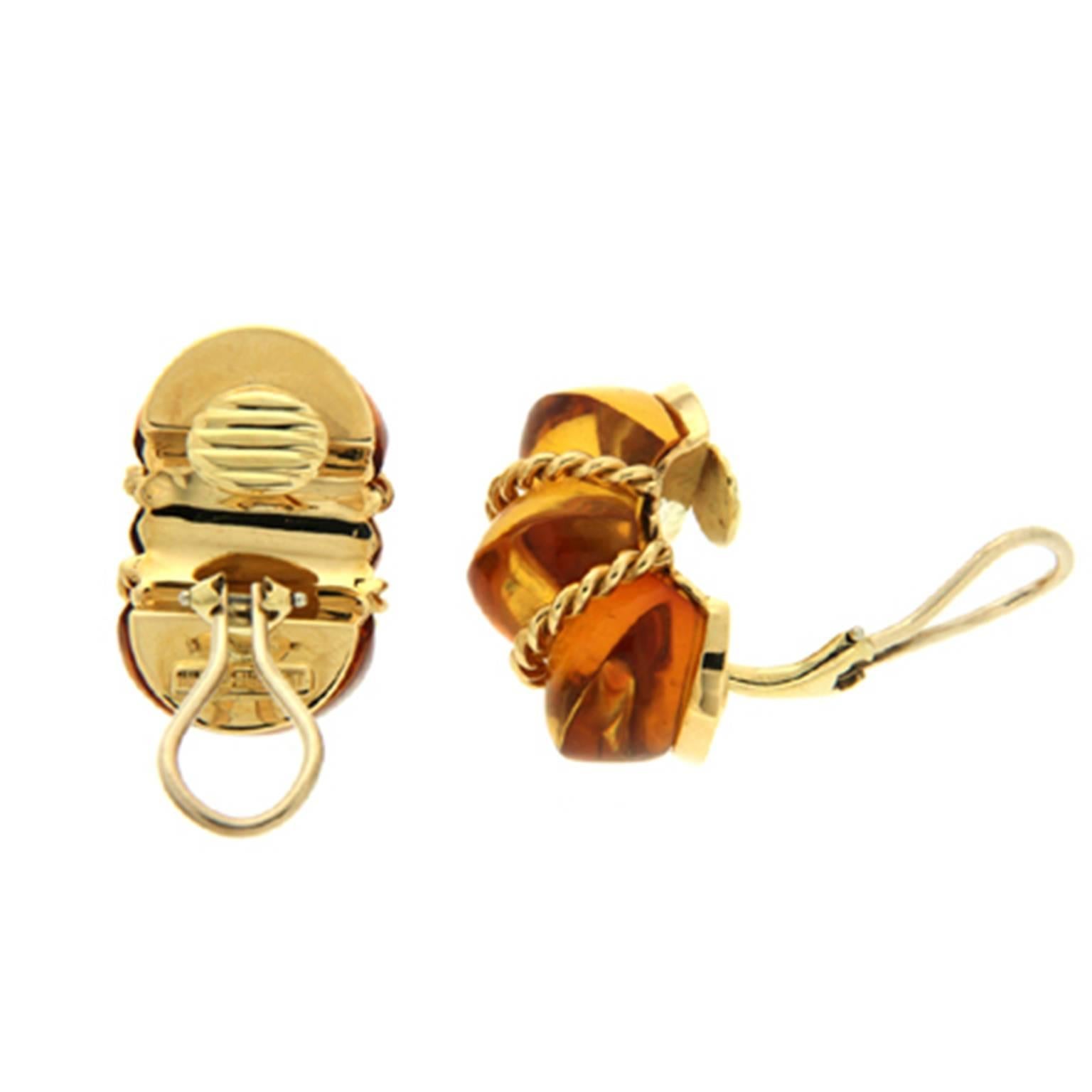 These earrings are made in 18kt yellow gold, they feature special cut Amber and are finished with clip-backs.