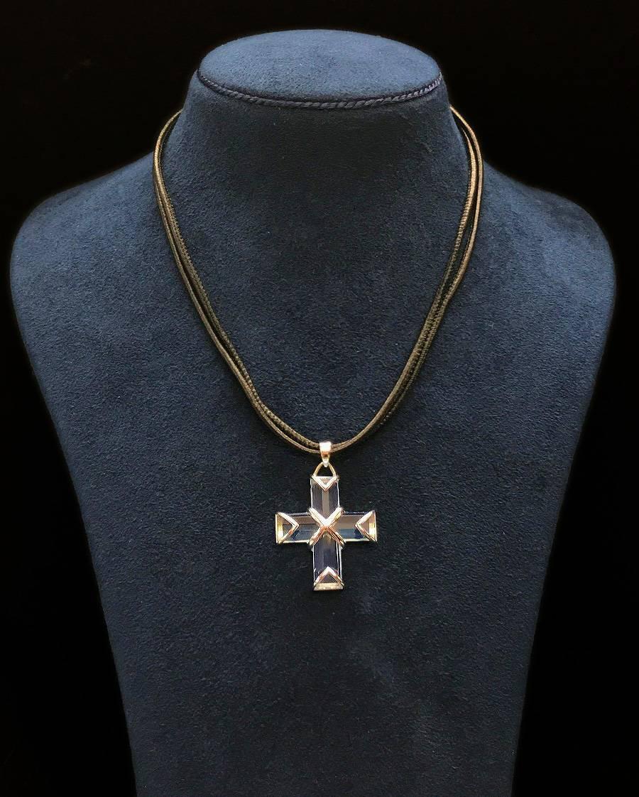 This unique cross pendant features cross shape blue topaz and is finished in 18kt white gold.
