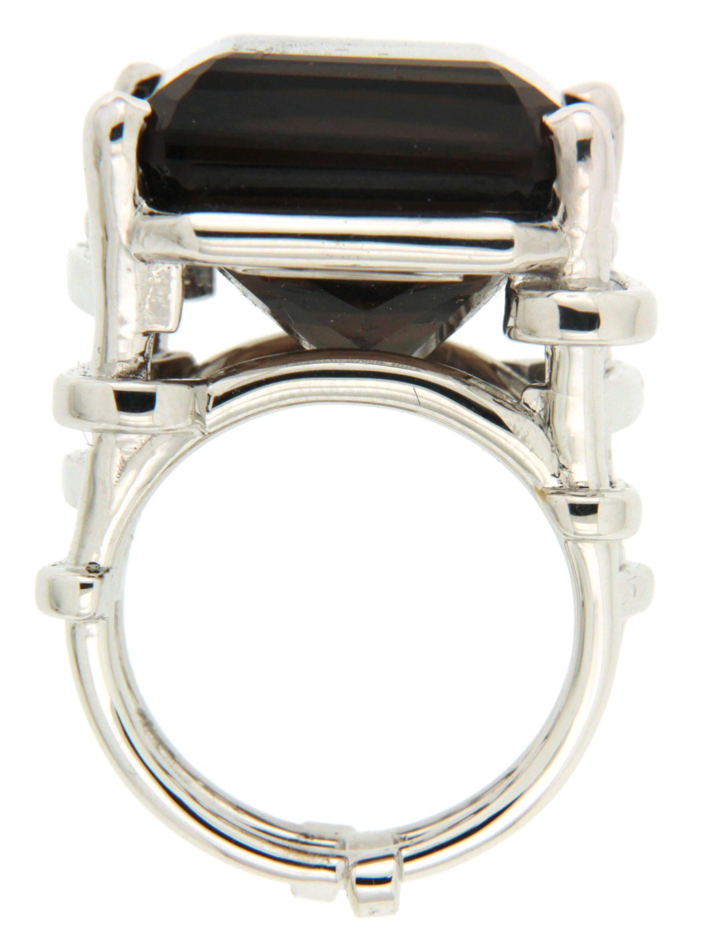This ring features an Emerald Cut Smokey Topaz of 29.83 ct and is designed with trellis shanks in 18kt white gold.