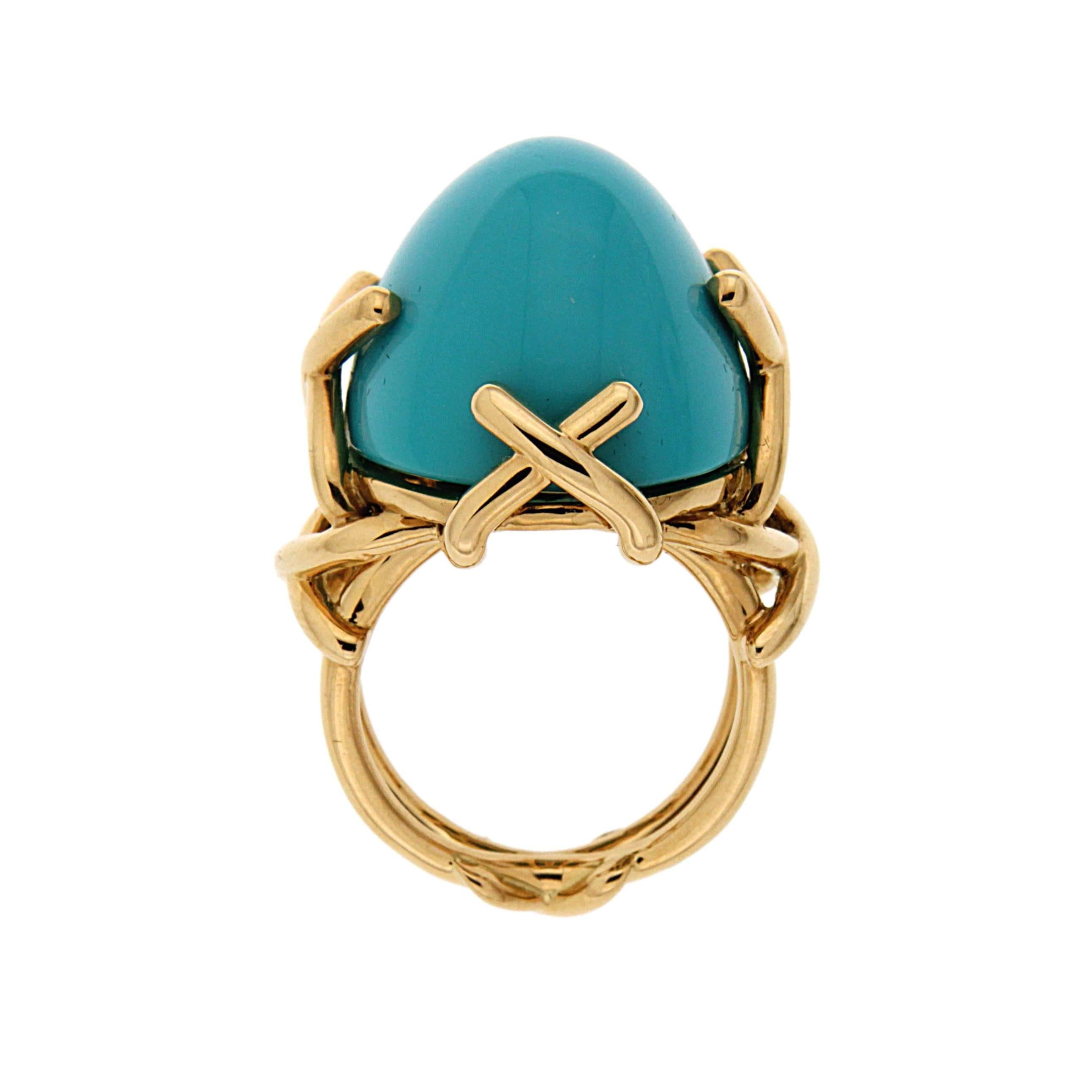 This ring is made in 18kt yellow gold trellis shank, it features an oval cabochon turquoise stone which measures 22x18mm.
