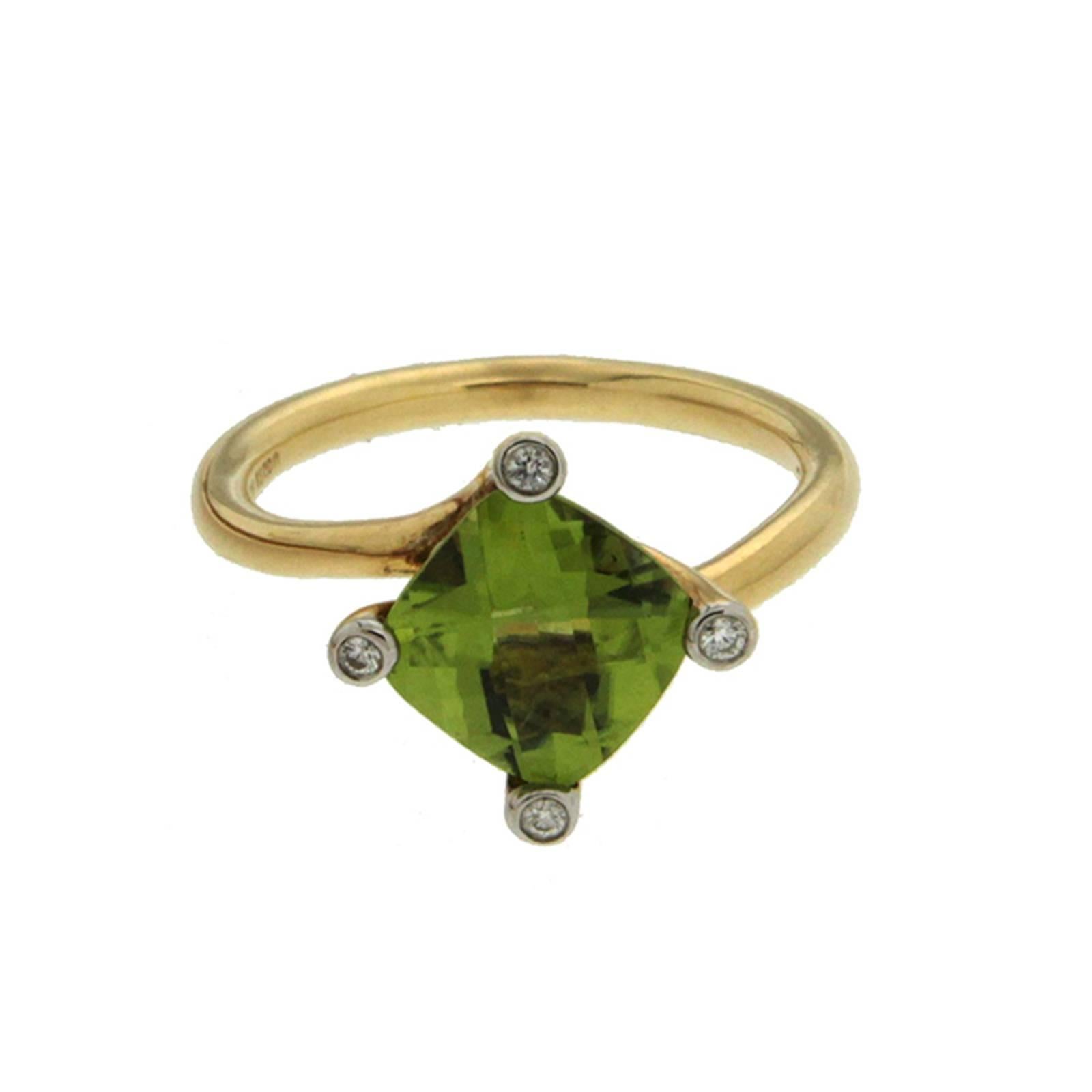 This lovely ring features a cushion 1.97ct Peridot center stone with diamonds in four prongs. The ring is completed in 18kt yellow gold with twist shanks.