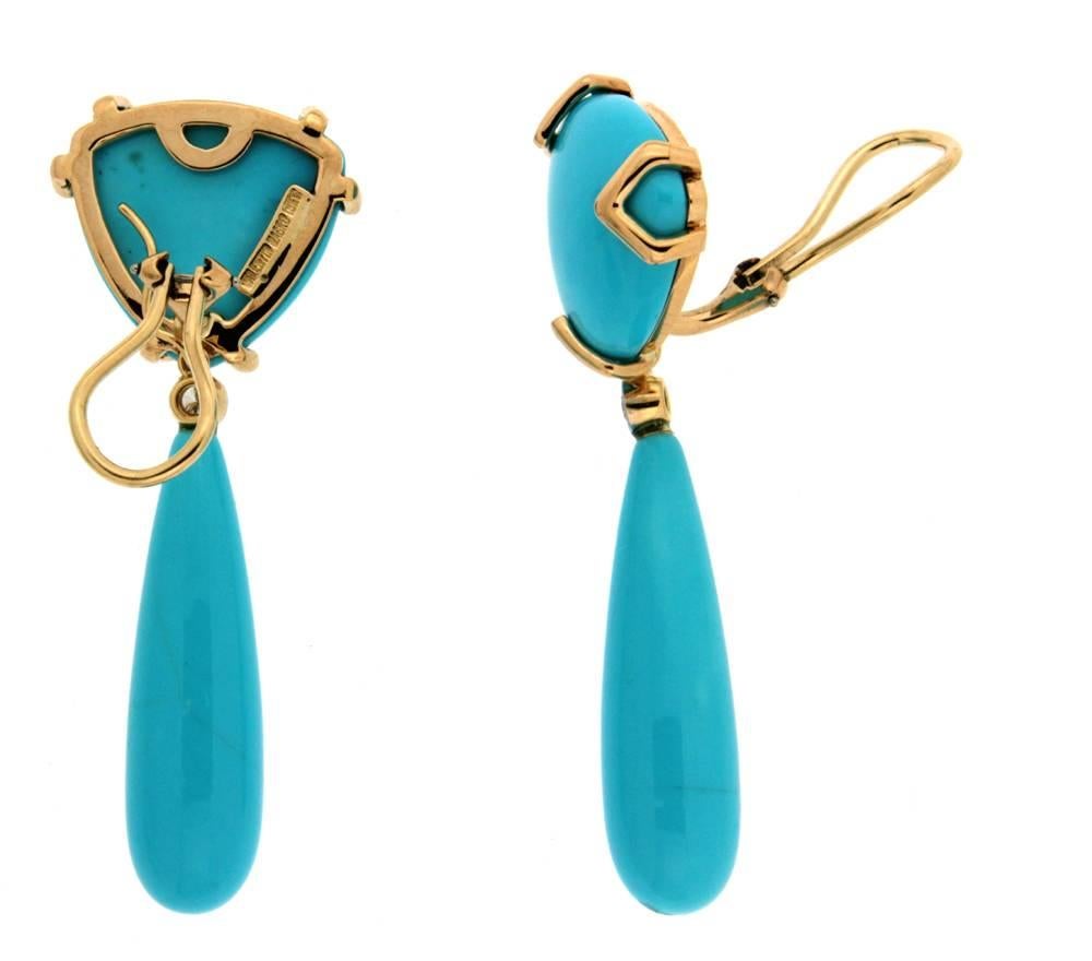 The earrings are made in 18kt yellow gold; they feature a special cut trilliant turquoise on the top part of the earrings which measures 20x20mm, a bezel set round brilliant diamond in the middle and a special cut turquoise drop which measures