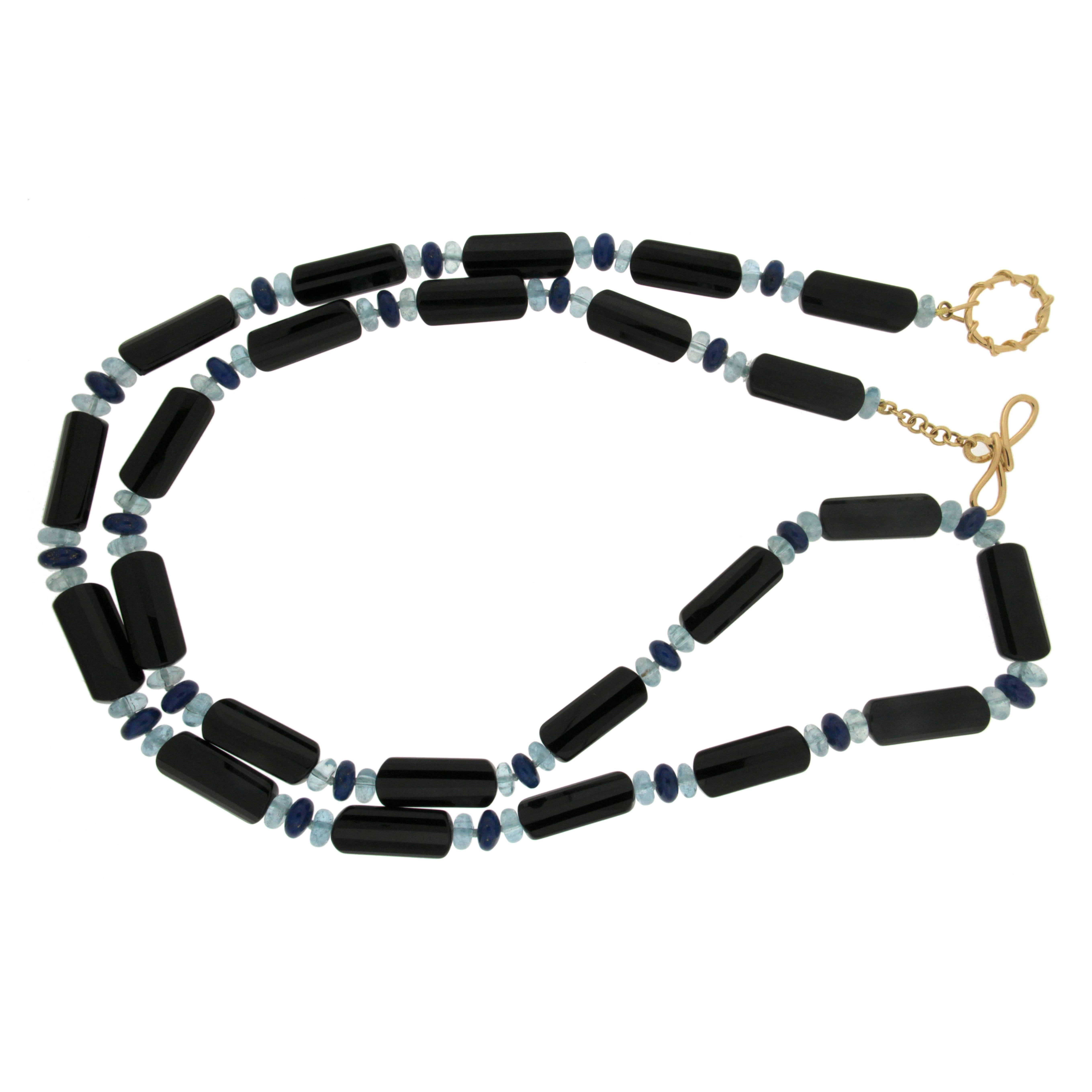 This unique necklace is made of Onyx tubes with Aquamarines and lapis roundels with large twisted Wire knot toggle and round wire loop in 18k Yellow Gold 