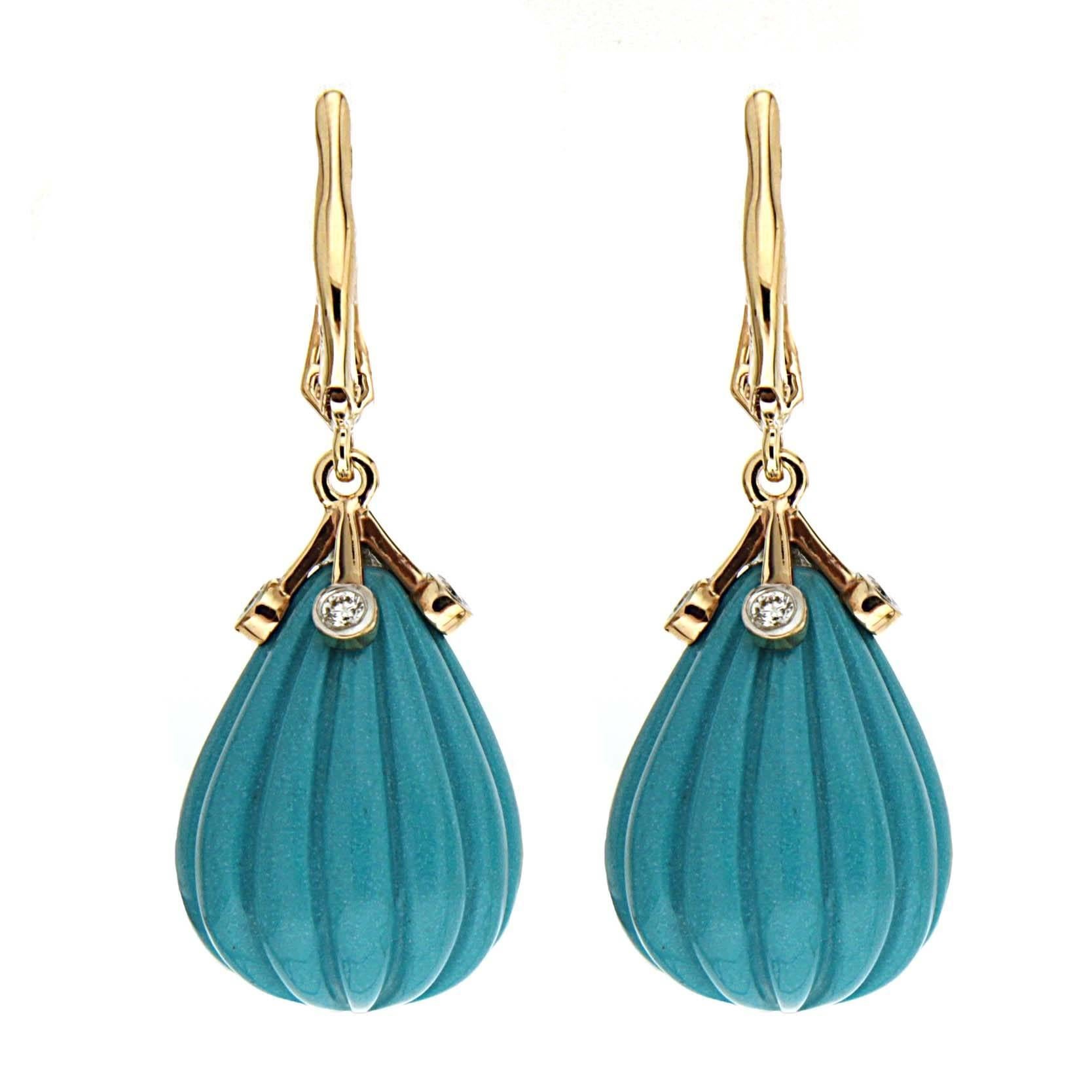 This lovely pair of earrings features carved drop of Turquoises with gold point diamond cap. The earrings are completed with diamond lever backs in 18kt Yellow Gold.