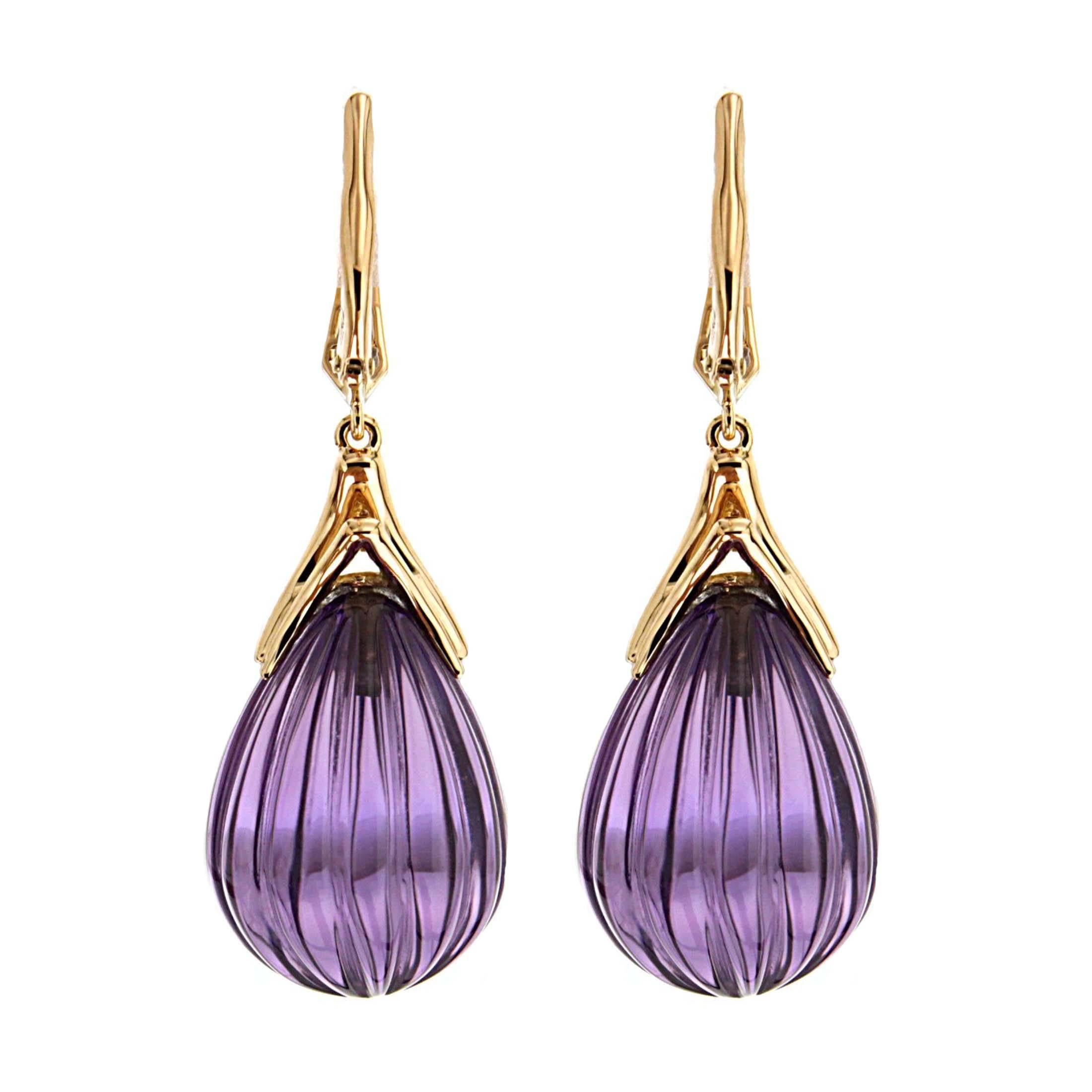 This lovely pair of earrings features carved drop of amethysts with gold curvy cap. The earrings are completed with diamond lever backs in 18kt Yellow Gold.