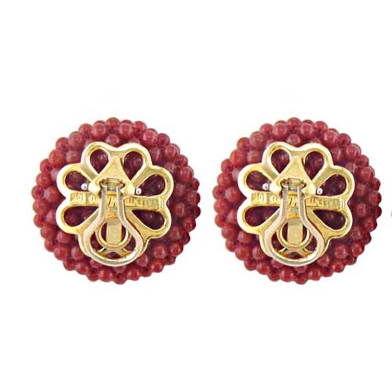 This lovely pair of earrings features red coral balls with 18kt yellow gold clip backs.