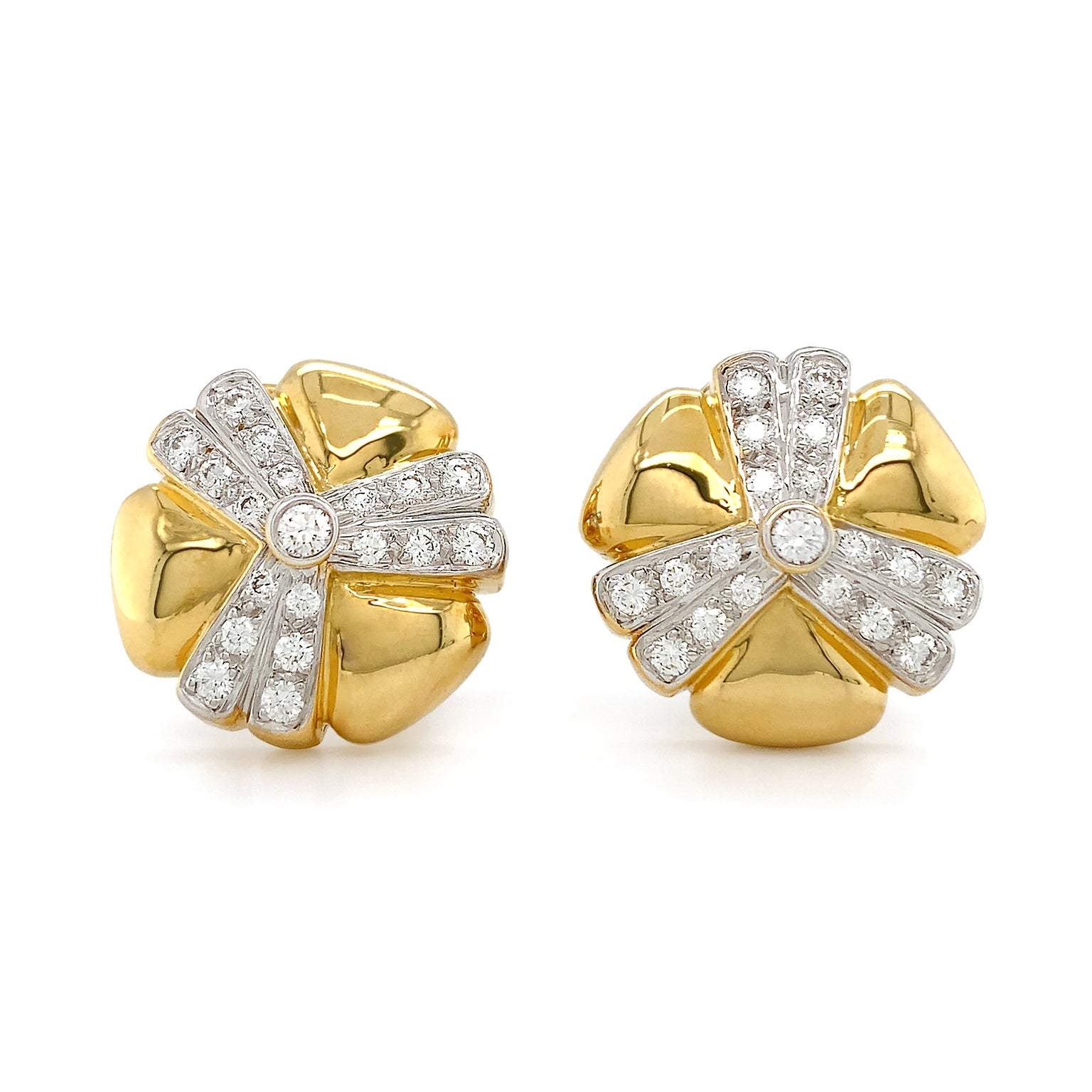 Radiant luster give these earrings a remarkable flare. 18k yellow gold triangles with rounded corners forms the outline of a clover. In between each section of gold, two rows of pave set brilliant cut diamonds sparkle, with a single diamond bezel