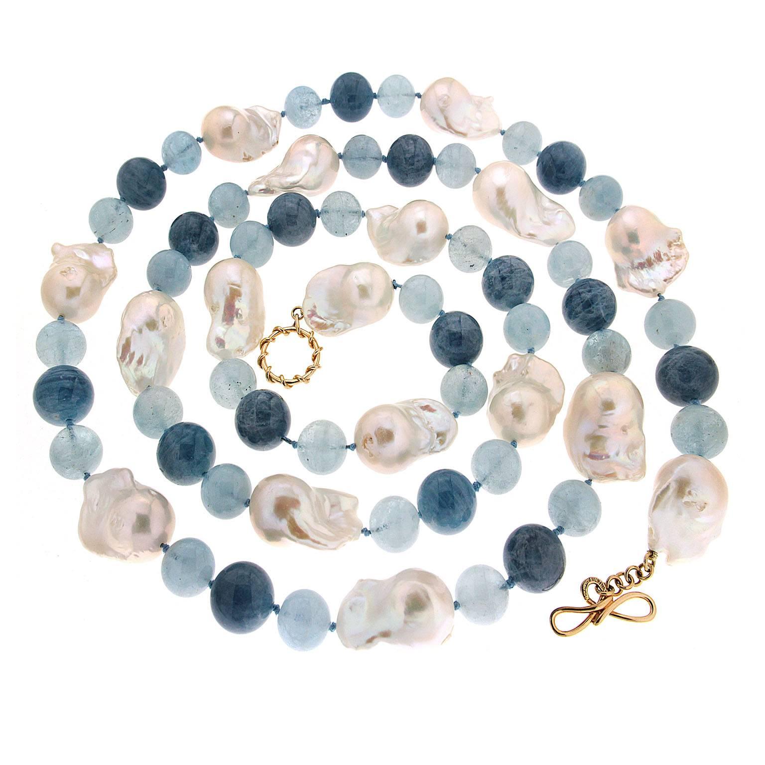 This necklace features 12mm and 14mm aquamarine balls and 17 large freshwater baroque pearls, it is finished with an 18kt yellow gold ring and toggle clasp. 