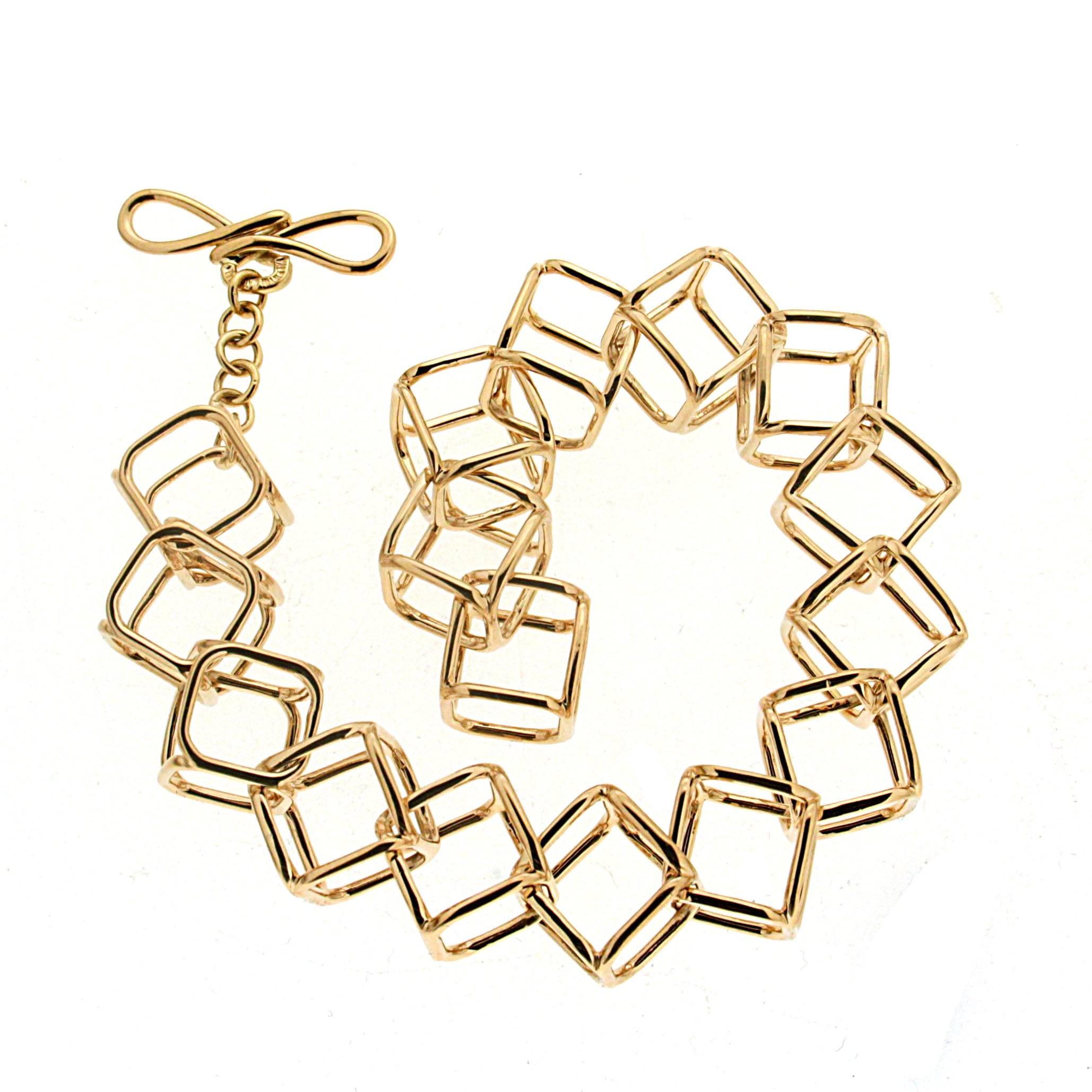 This lovely Interlocking Cushion Cube Link Bracelet is made in 18kt yellow gold with ring and toggle. There are matching necklace and earrings.