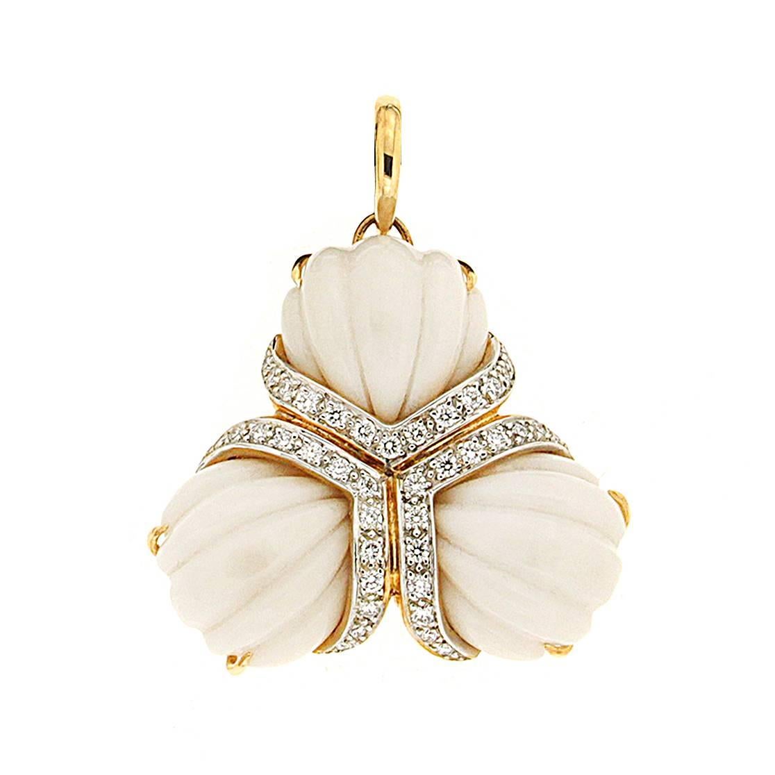 This pendant is made in 18kt yellow gold, it features cocolon and round brilliant diamonds with a carat total weight of 0.72 ctw.